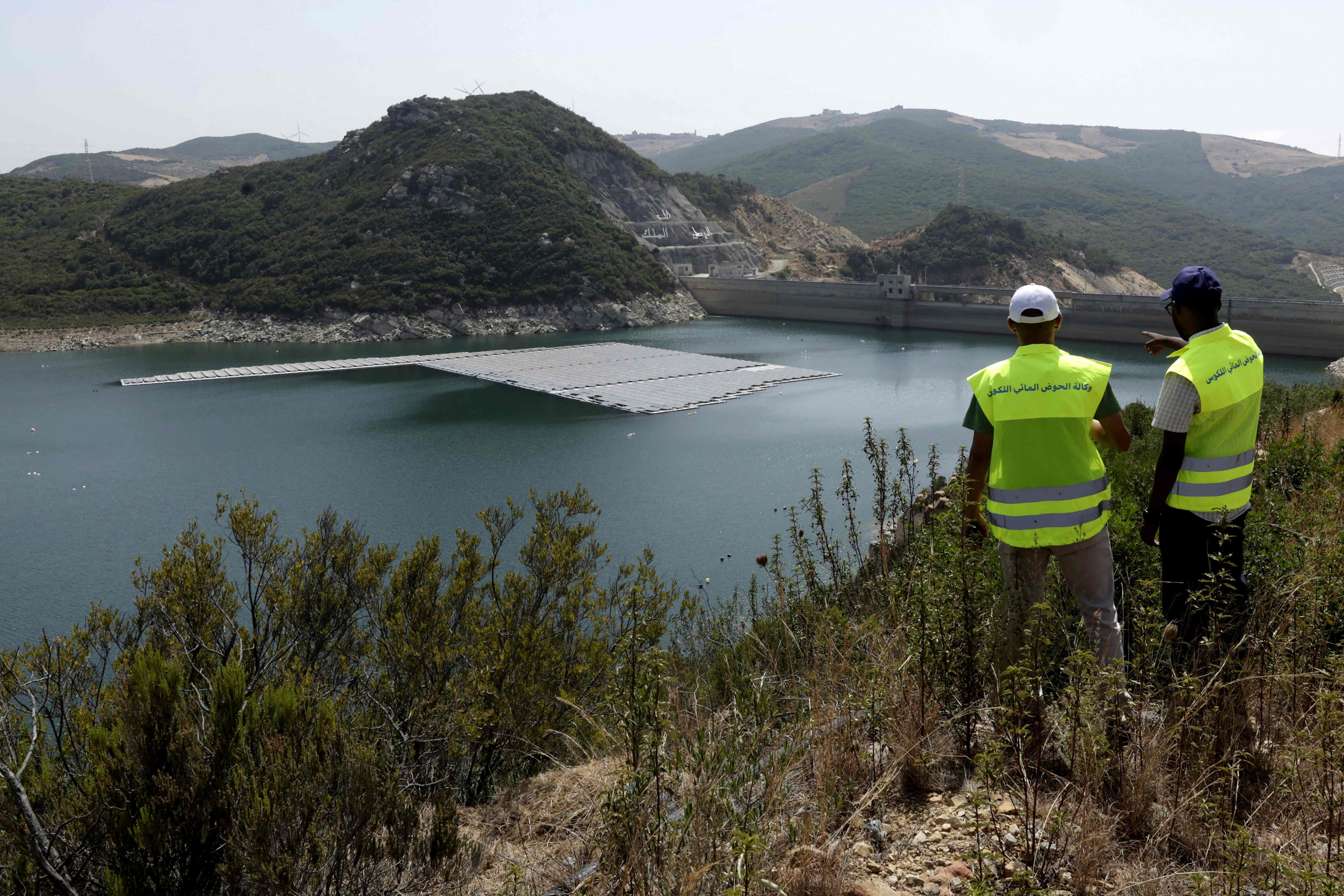 Workers inspect a floating photovoltaic solar installation on the Oued Rmel dam near the city of Tangiers in Morocco. Photo: AFP