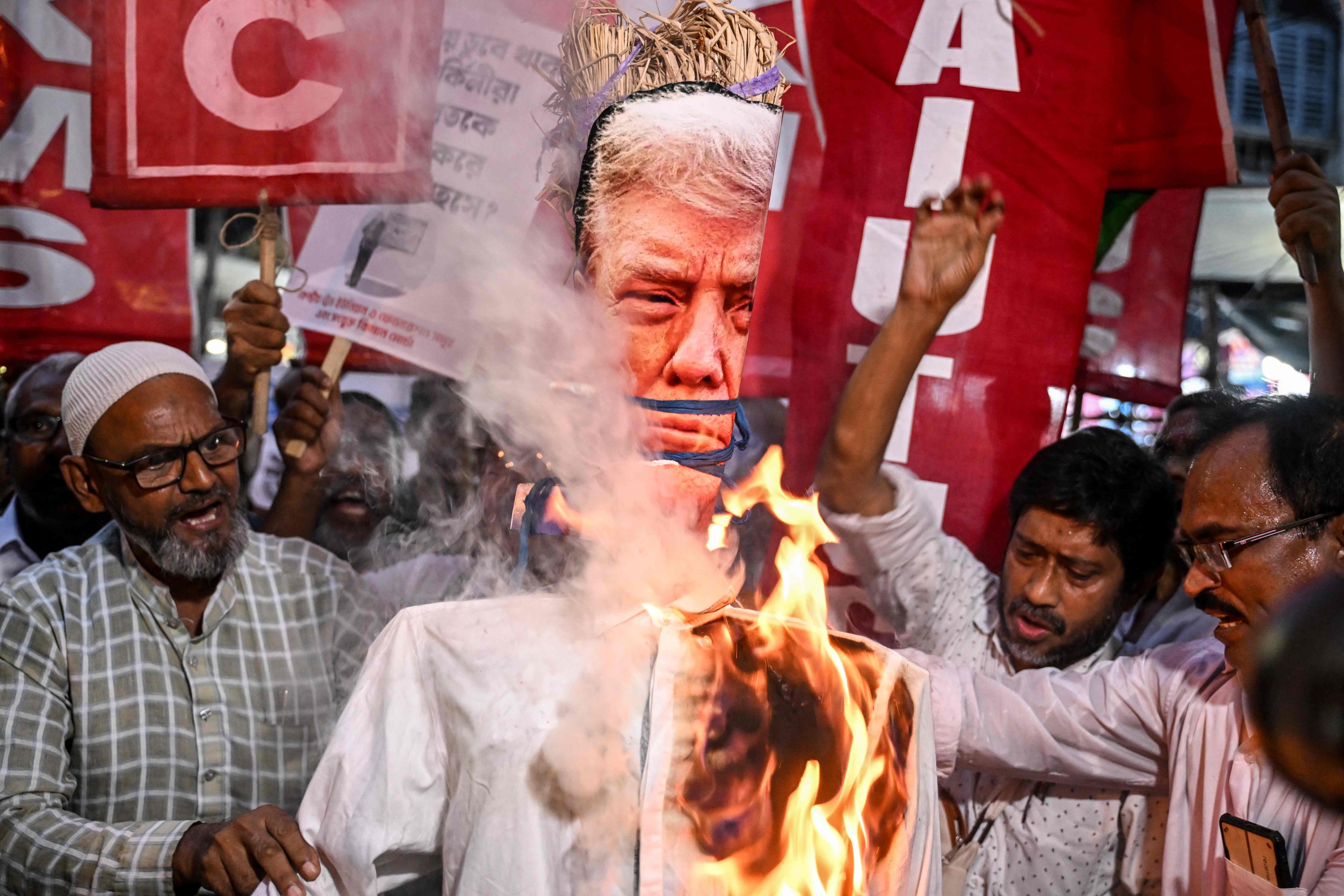 Indian activists burn an effigy of US President Donald Trump earlier this month to protest against tariff increases. Photo: AFP