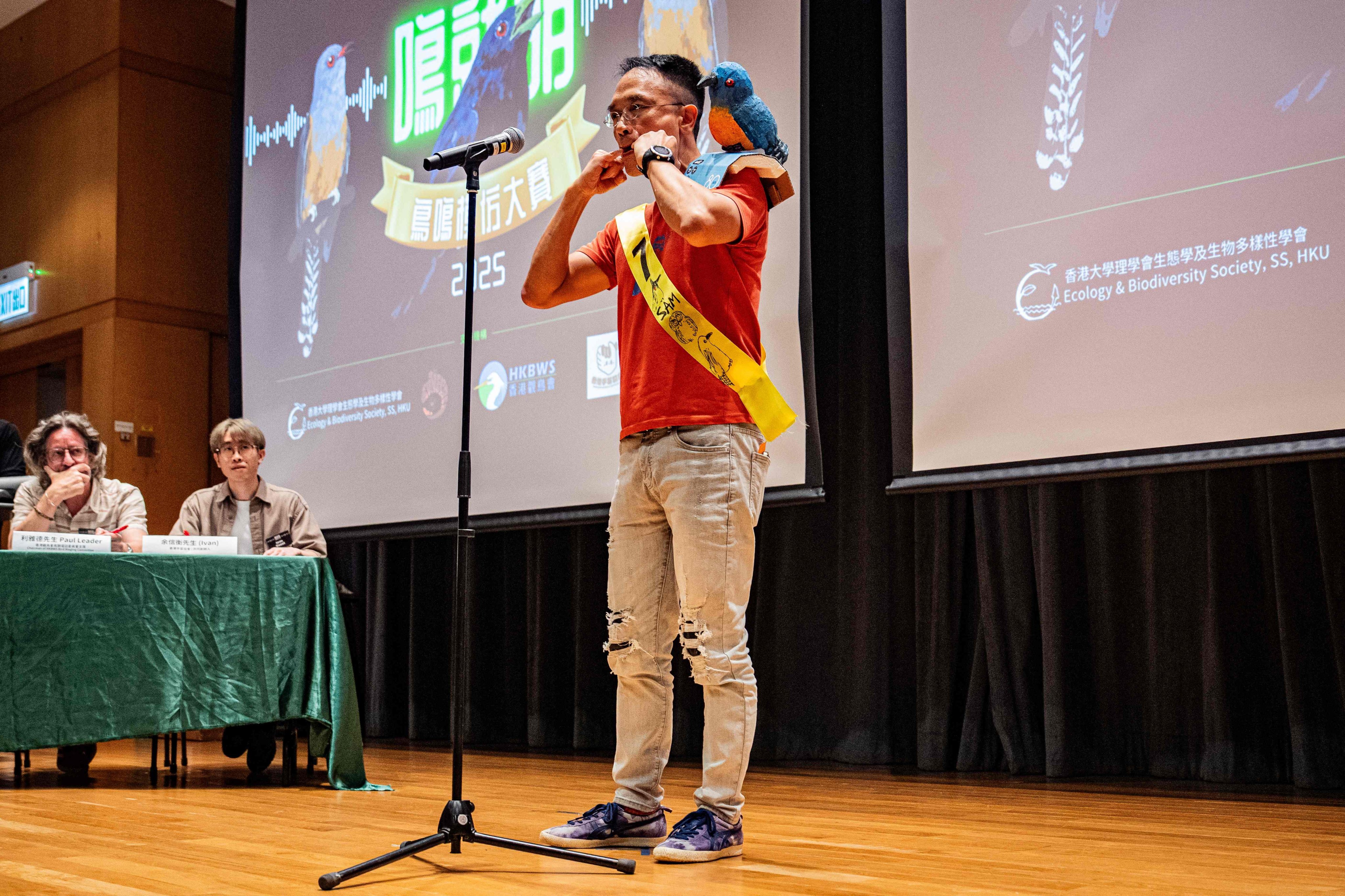 A participant, wearing a bird-themed decoration, mimics bird calls during the Hong Kong Bird Watching Society’s bird call competition at the University of Hong Kong on August 23. Photo: AFP