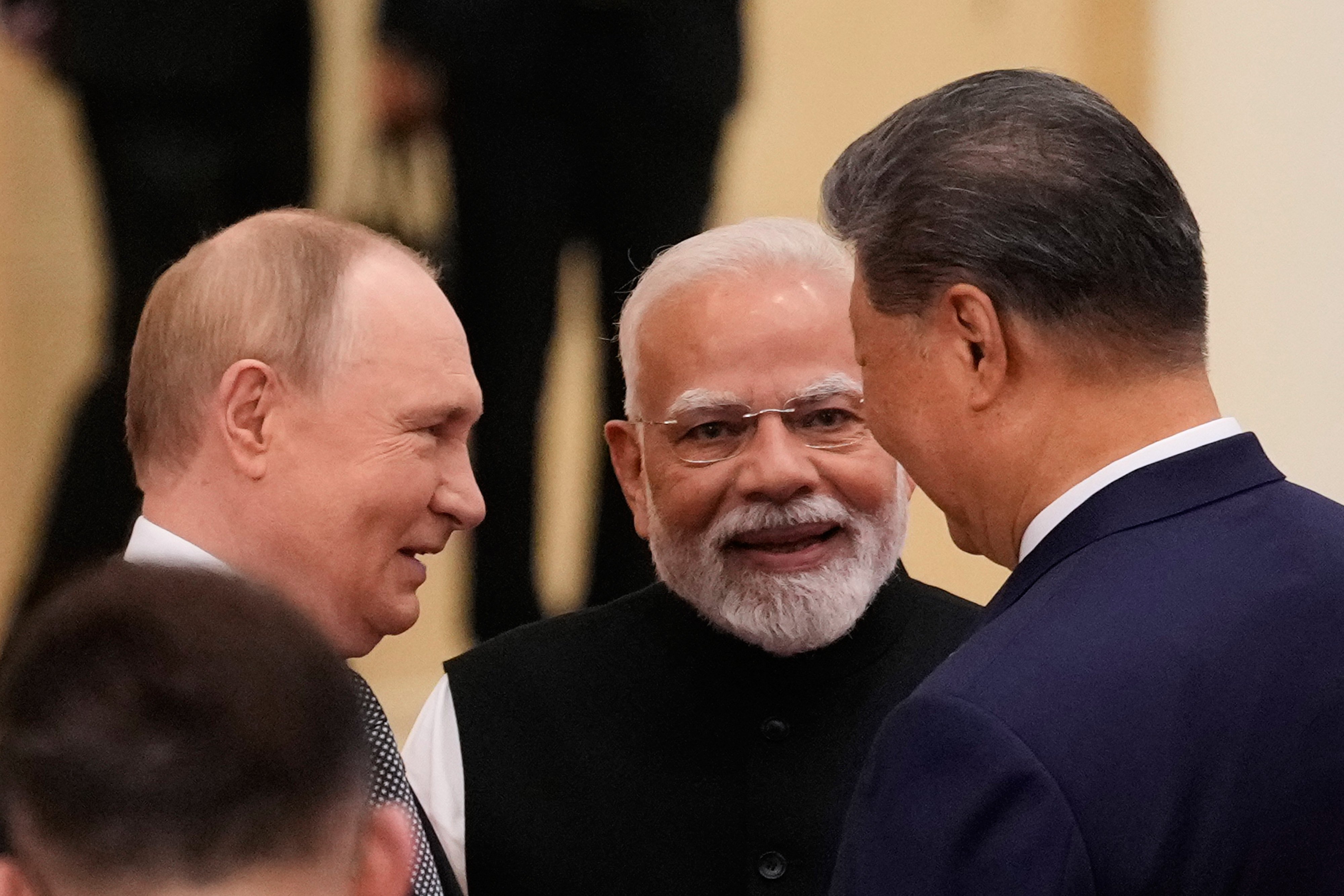 Russian President Vladimir Putin (left), Indian Prime Minister Narendra Modi (centre) and Chinese President Xi Jinping (right) talk ahead of the Shanghai Cooperation Organization summit in Tianjin, China, on Monday. Photo: AP