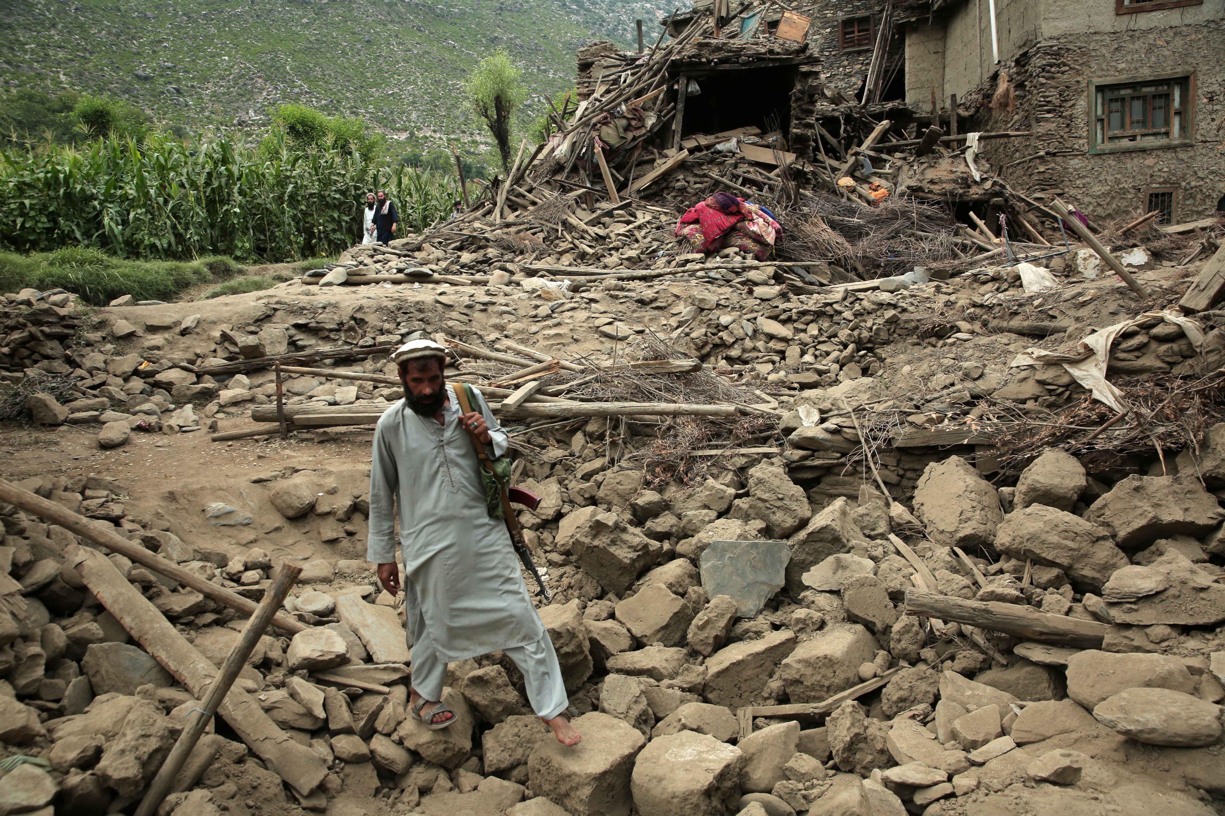 A man walks over rubble in earthquake-hit Kunar province, Afghanistan. Photo: EPA