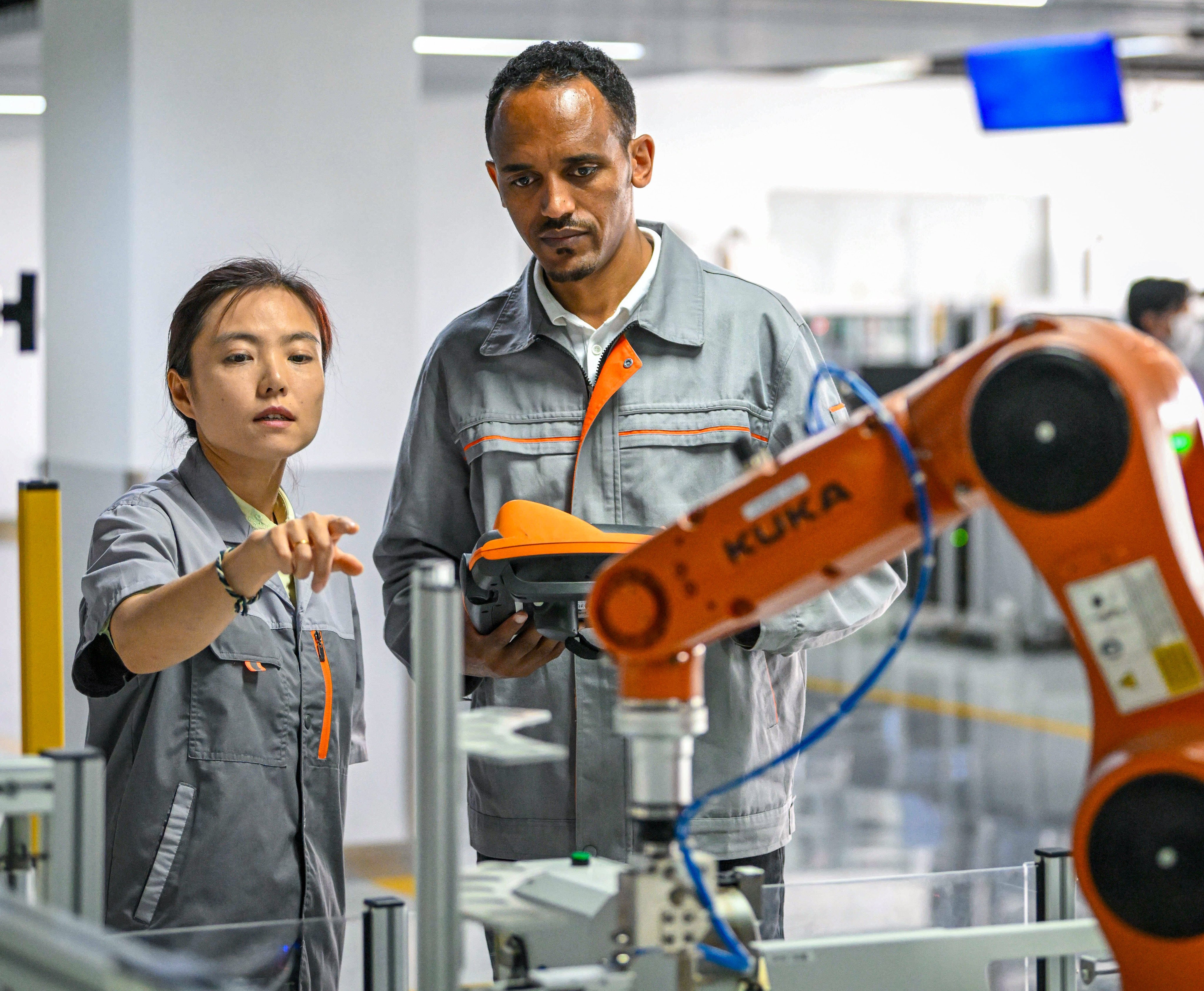 Tola Tsegaye Alemu, right, a Luban workshop graduate, operates an industrial robot under the guidance of a teacher at Tianjin University of Technology and Education. Photo: Xinhua