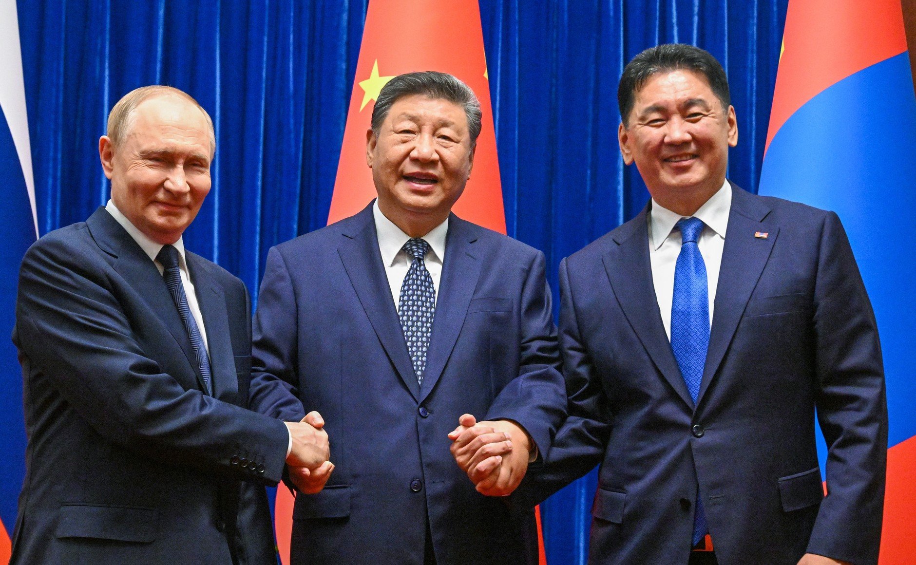 Chinese President Xi Jinping with his Russian and Mongolian counterparts ahead of their meeting at the Great Hall of the People in Beijing. Photo: Kremlin/dpa
