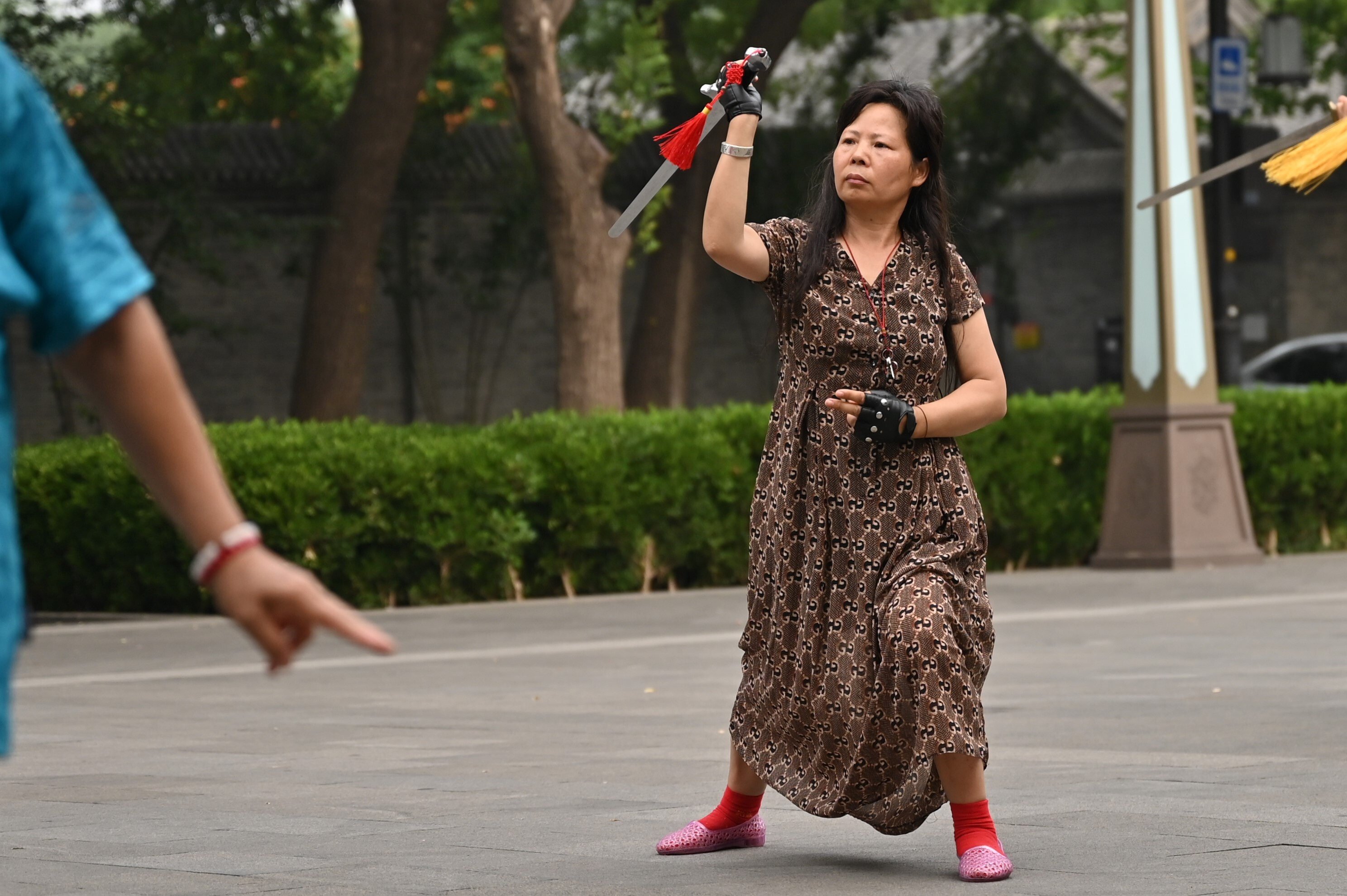 A Chinese woman practises tai chi with a sword in Beijing. Photo: dpa