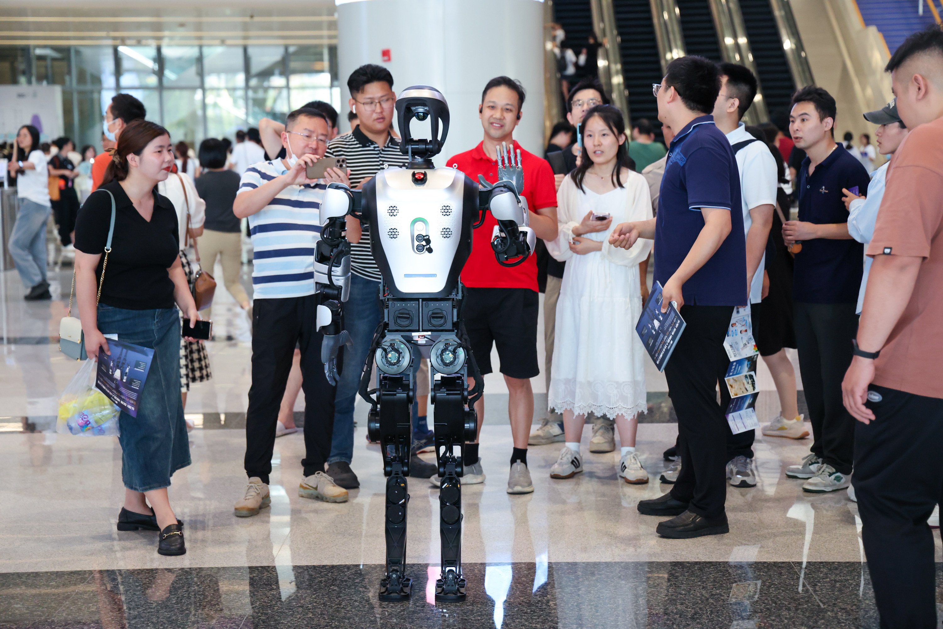 People interact with a robot during the Guangdong-Hong Kong-Macau Greater Bay Area International Auto Show in Shenzhen in May. Photo: Xinhua