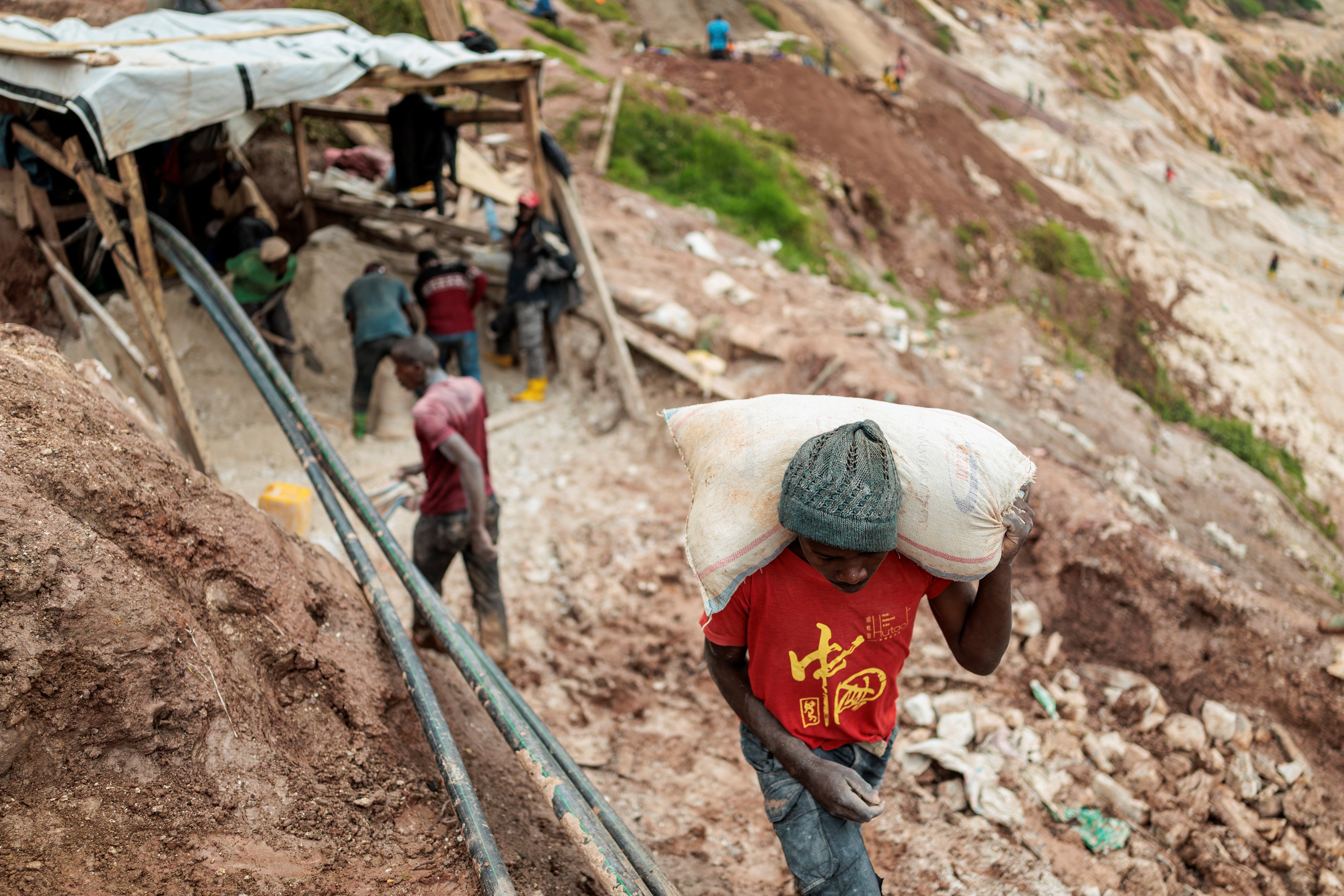 A labourer carries a sack of ore at the Rubaya coltan mine in the Democratic Republic of Congo on March 24. Photo: Reuters