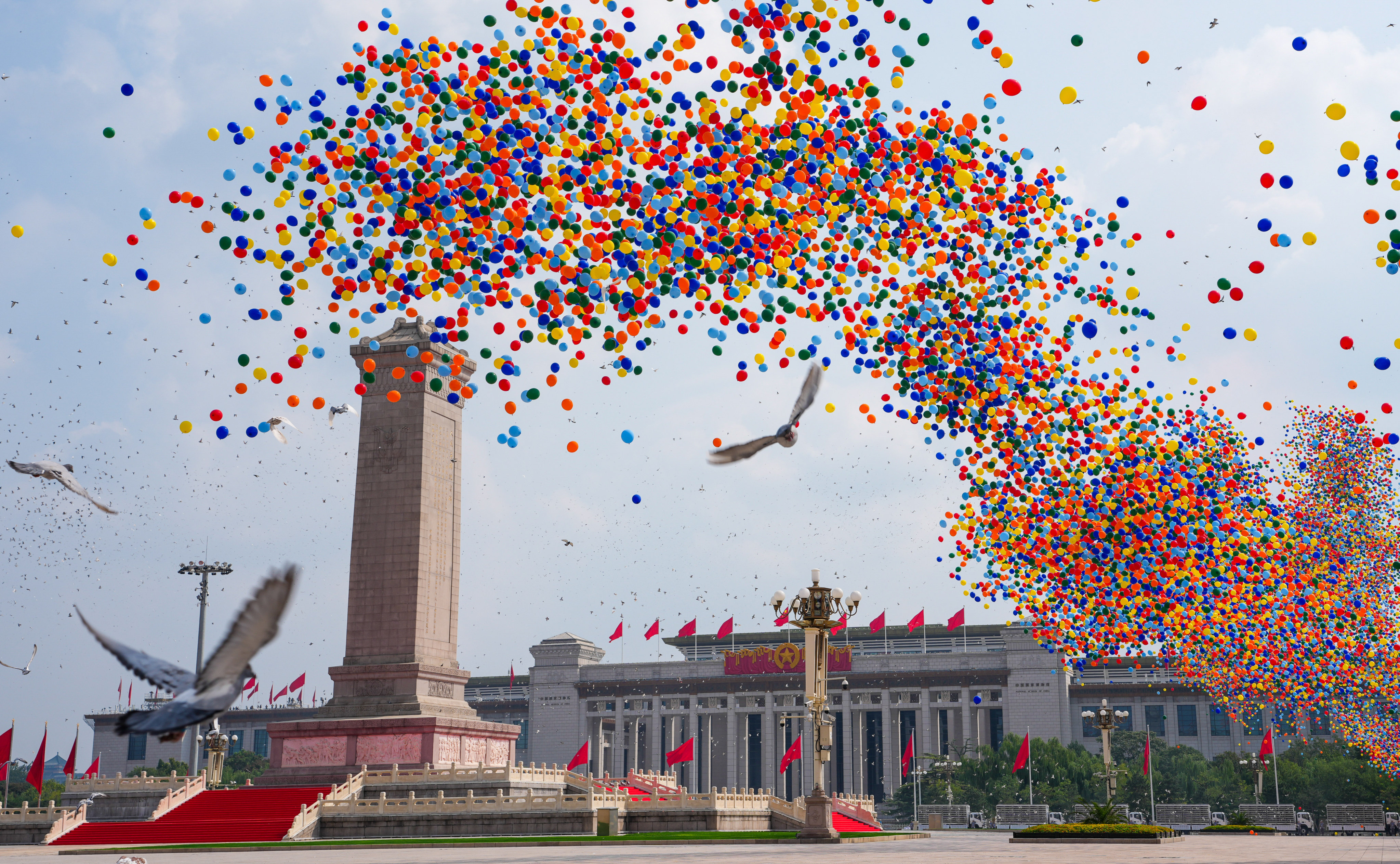 Pigeons and balloons are released into the sky over Tiananmen Square in Beijing on Wednesday, as part of the 80th anniversary commemorations. Photo: Xinhua