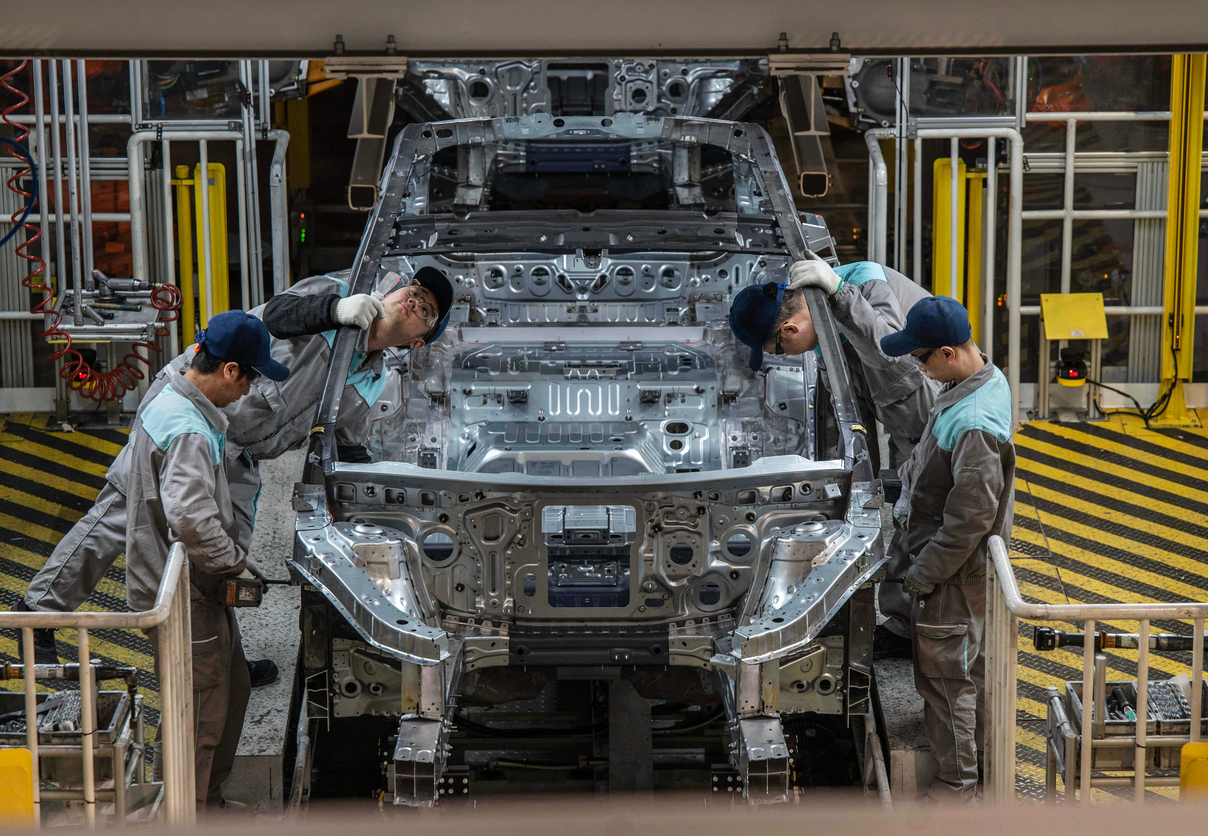 Nio’s EV workers inspected a vehicle chassis on an automated production line in eastern China’s Hefei city on January 17, 2025. Photo: Getty Images