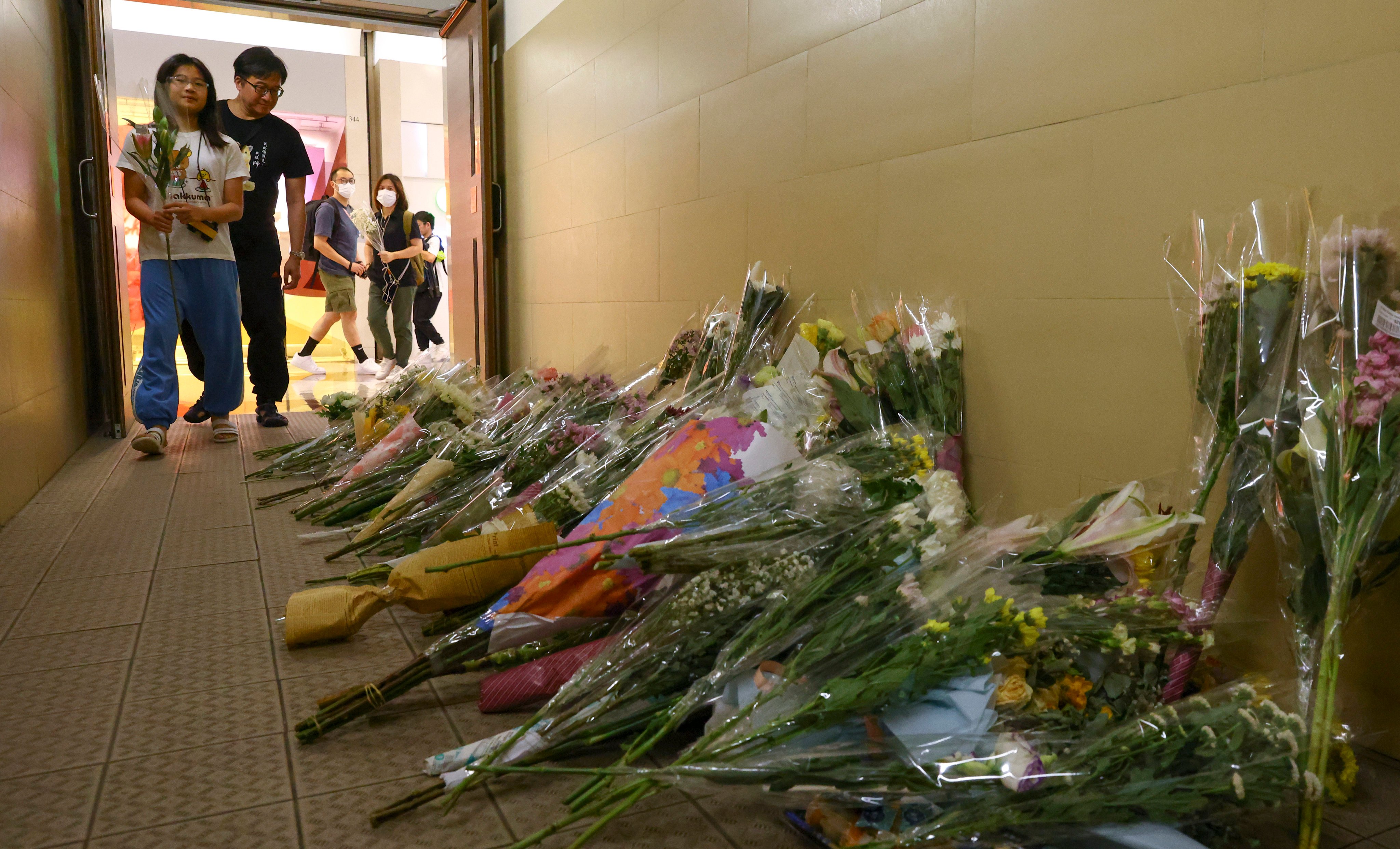 People lay flowers on June 3, 2023, to mourn two shoppers who were stabbed to death by a man at a shopping centre in Diamond Hill the previous day. Photo: Dickson Lee