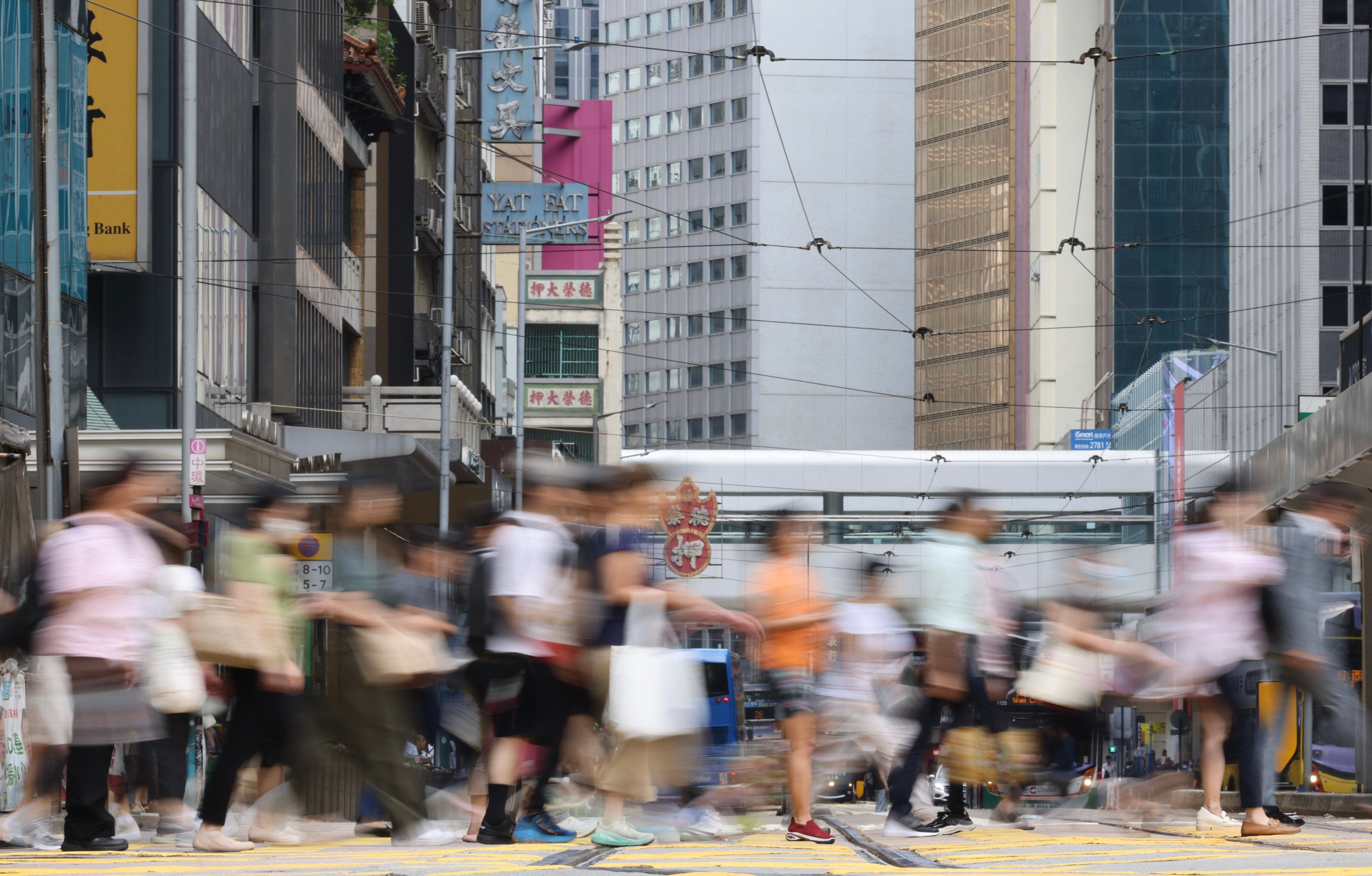 Pedestrians on a street in Central on August 21, 2025. Photo: Karma Lo