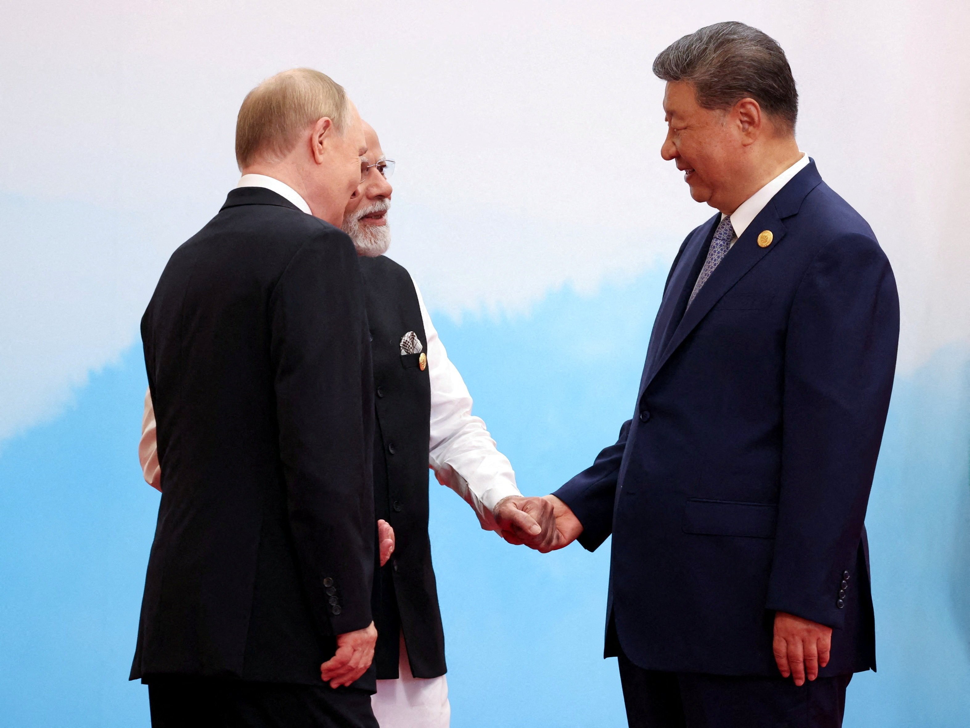 Chinese President Xi Jinping, Indian Prime Minister Narendra Modi and Russian President Vladimir Putin speak during the Shanghai Cooperation Organisation summit in Tianjin on September 1. Photo: Sputnik / Pool via Reuters