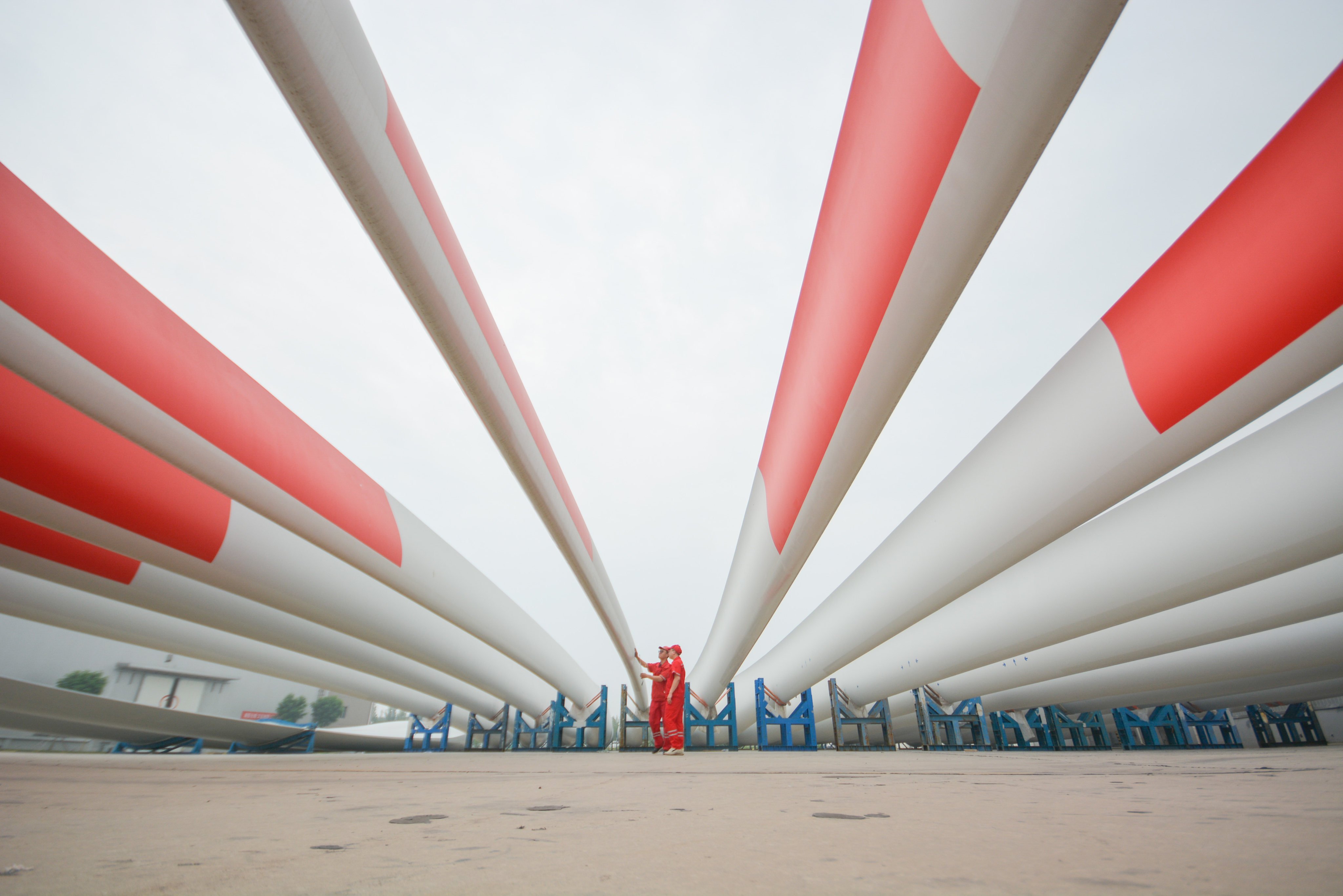 New wind turbine blades sit at a factory on July 15, 2022 in Handan, in China’s northern province of Hebei. Photo: VCG via Getty Images