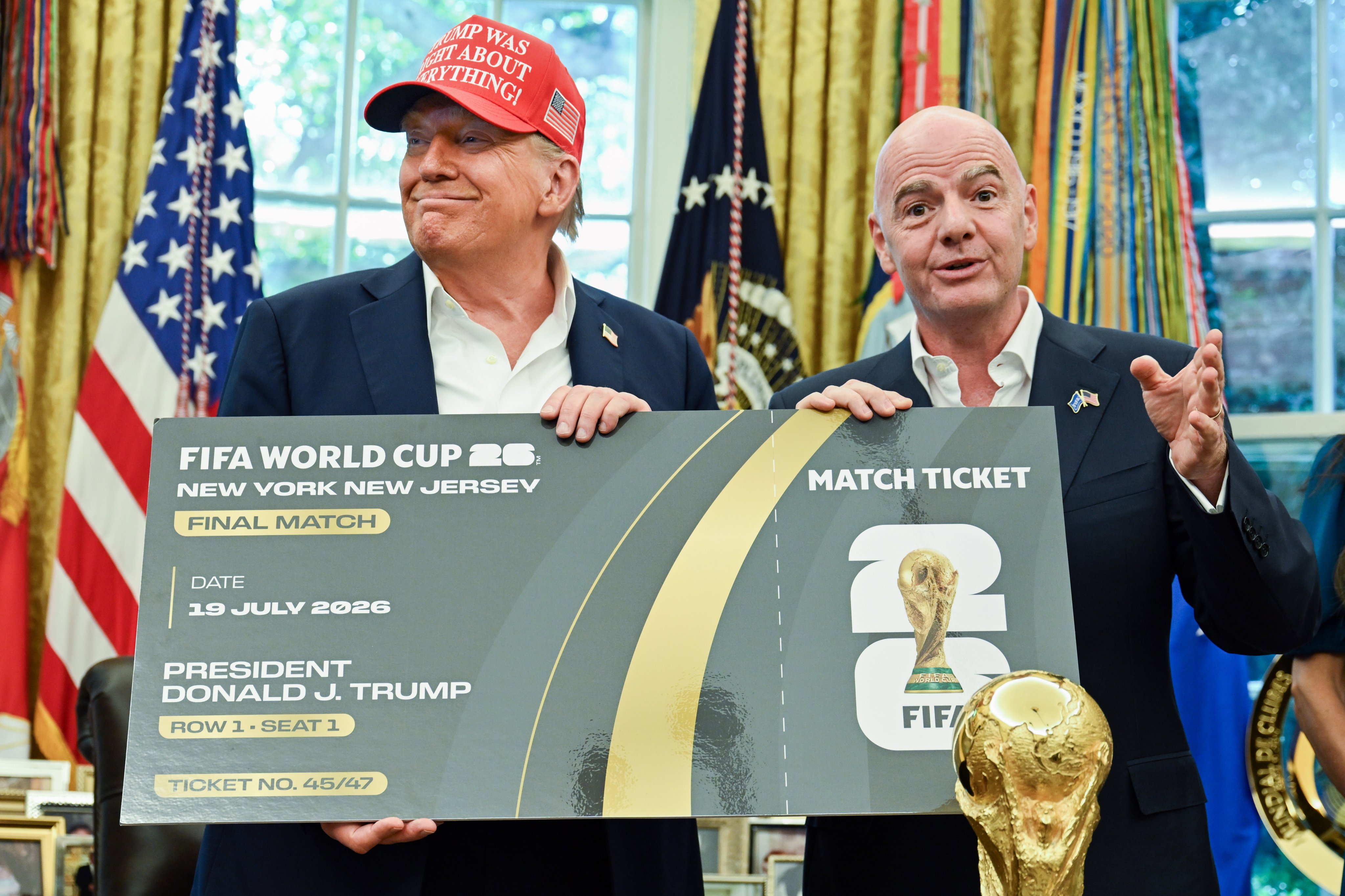 President Donald Trump (left) and Fifa president Gianni Infantino hold a ticket to the 2026 World Cup  in the Oval Office. Photo: EPA