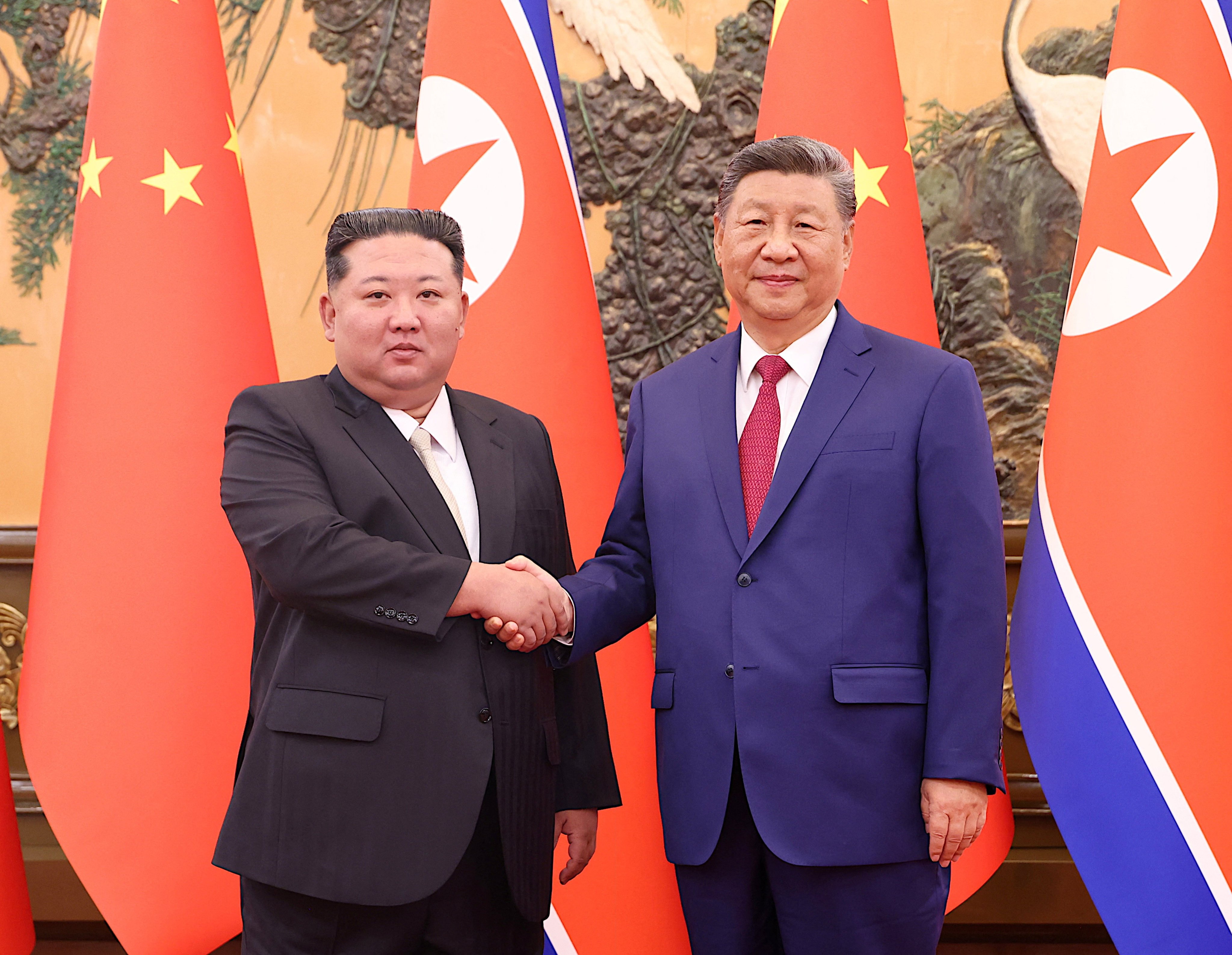 Chinese President Xi Jinping (right) and North Korean leader Kim Jong-un meet for talks at the Great Hall of the People in Beijing on Thursday. Photo: China Daily via Reuters
