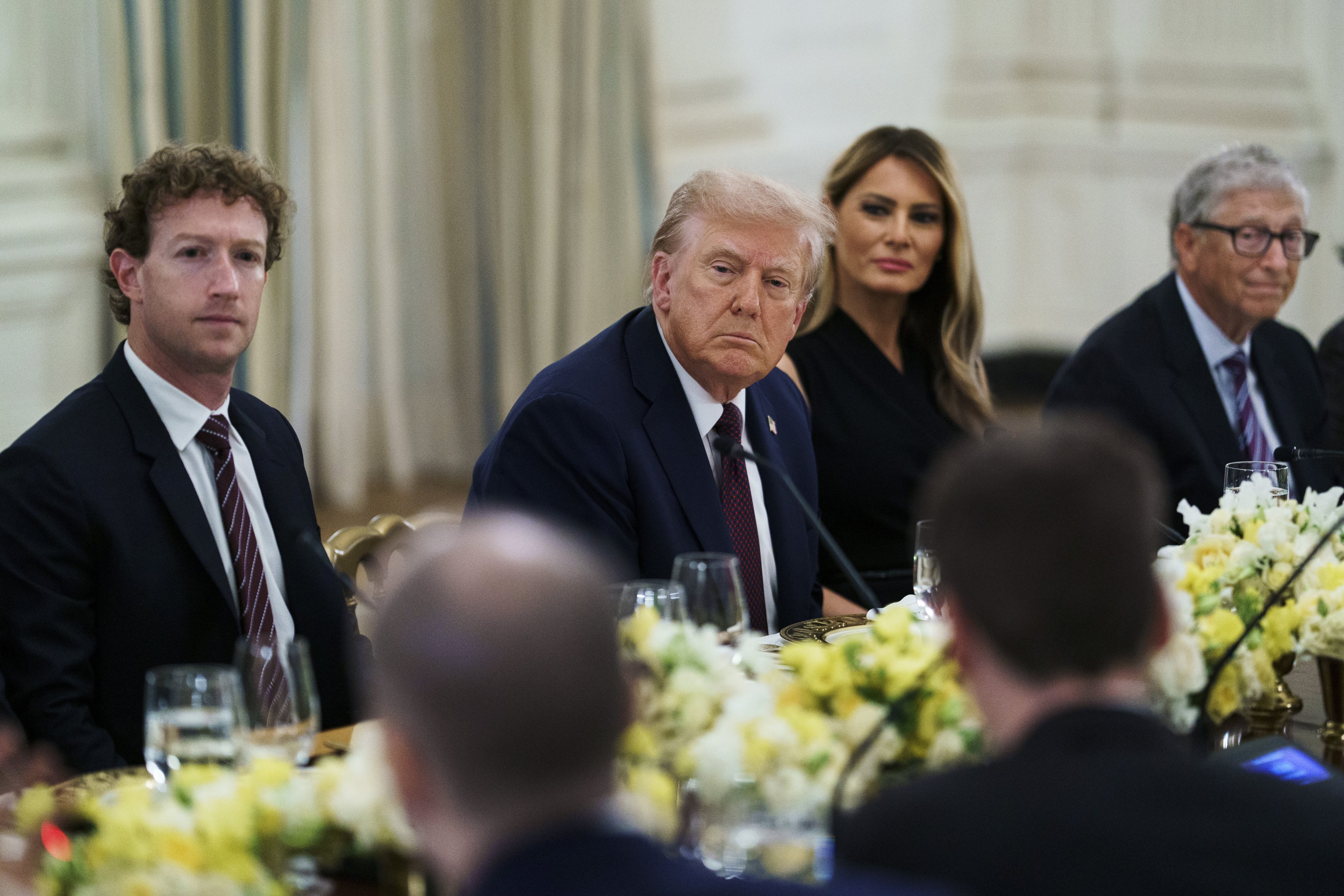 US President Donald Trump seated next to wife, Melania, and Microsoft founder Bill Gates to the right and Meta Platforms CEO Mark Zuckerberg to the left, during a dinner with US tech leaders at the White House on Thursday. Photo: EPA