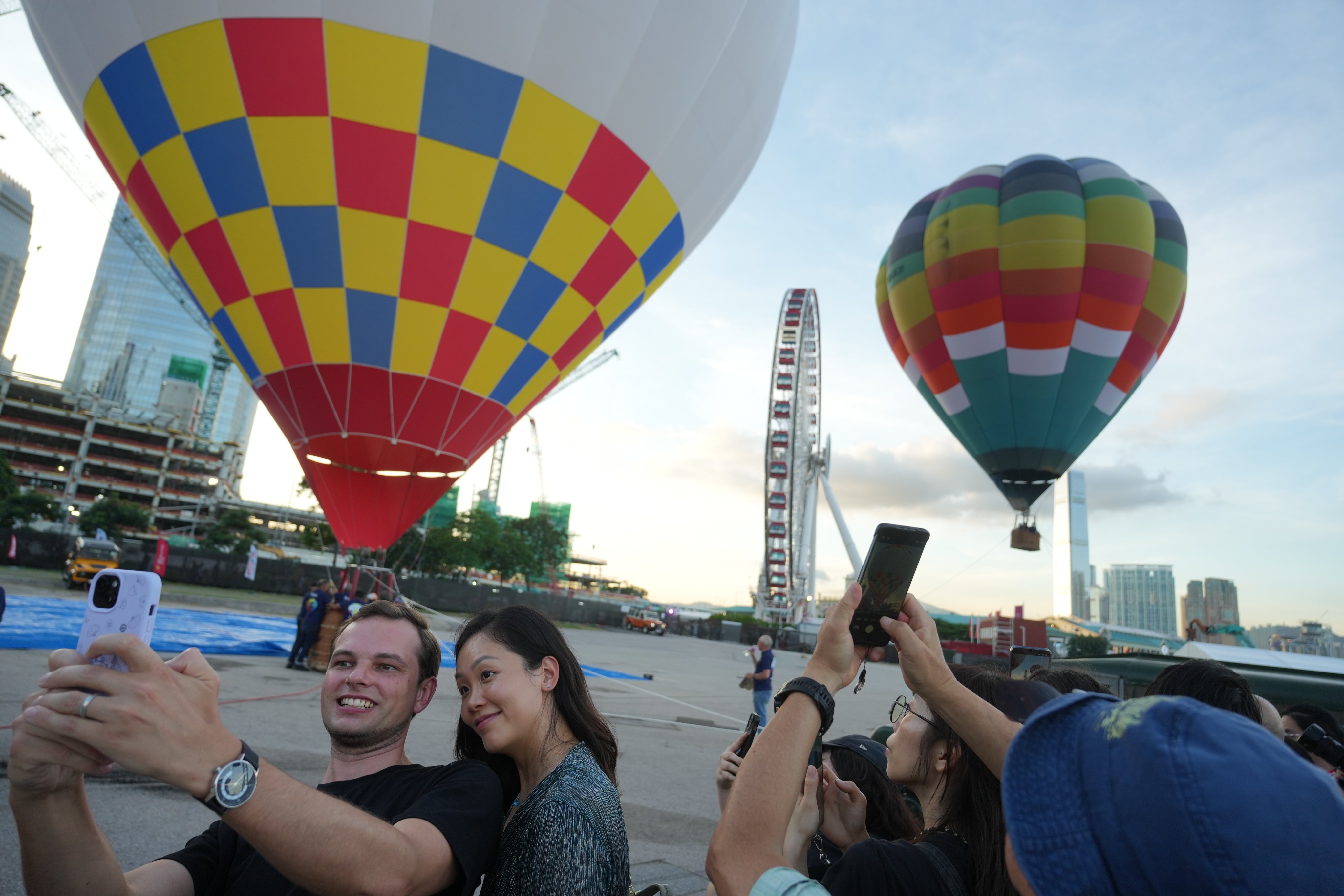 People take photos during a media preview of Hong Kong’s first hot-air balloon festival at the Central harbourfront on September 4. Photo: Sam Tsang