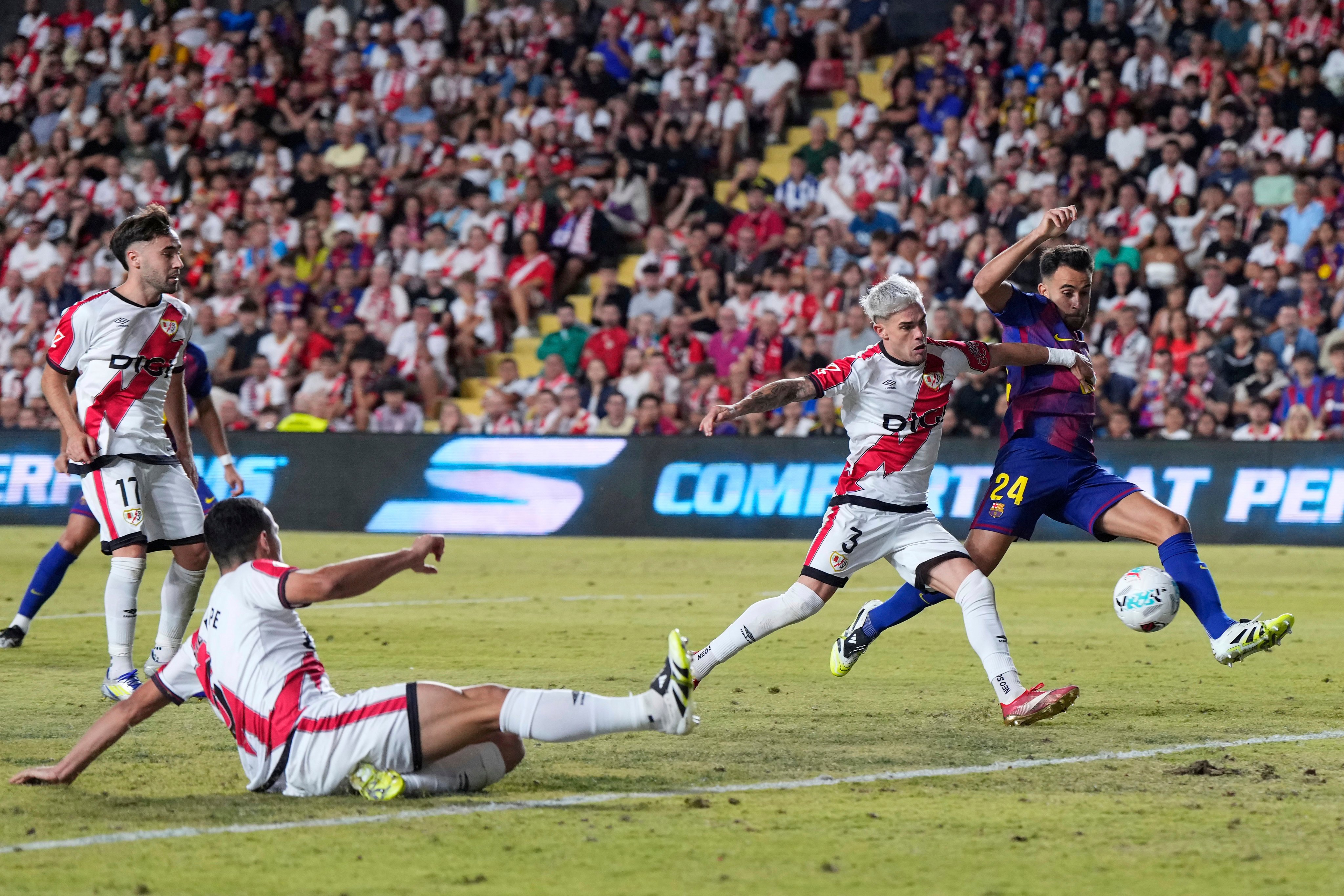 Barcelona (in blue and red) and Rayo Vallecano contest a La Liga match in Madrid last Sunday. Photo: AP
