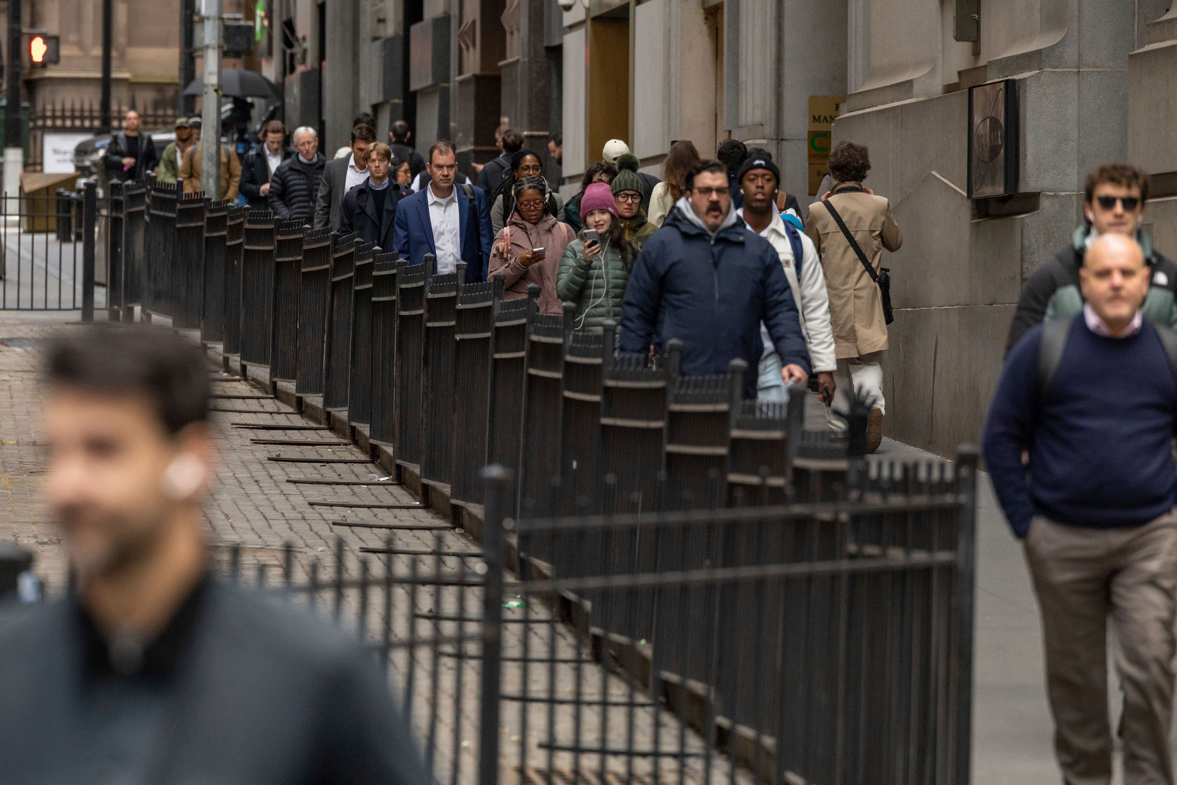 Commuters pass the New York Stock Exchange. The unemployment rate ticked up to 4.3 per cent, also worse than expected and the highest level since 2021. Photo: AP