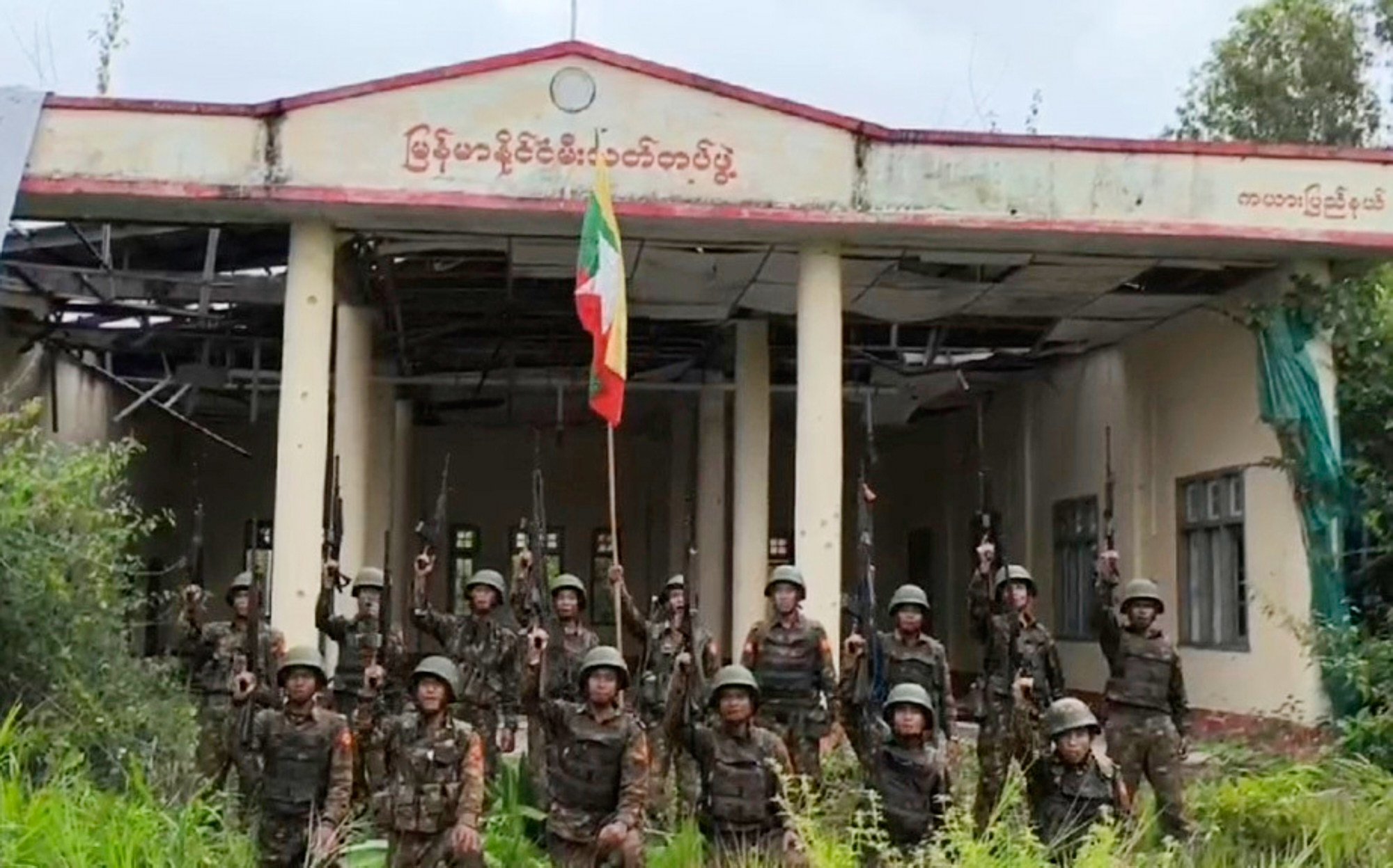 Myanmar soldiers pose in front of a captured fire station in the eastern state of Kayah, which the junta said it recaptured from resistance forces last month. Photo: Myanmar Military/AP