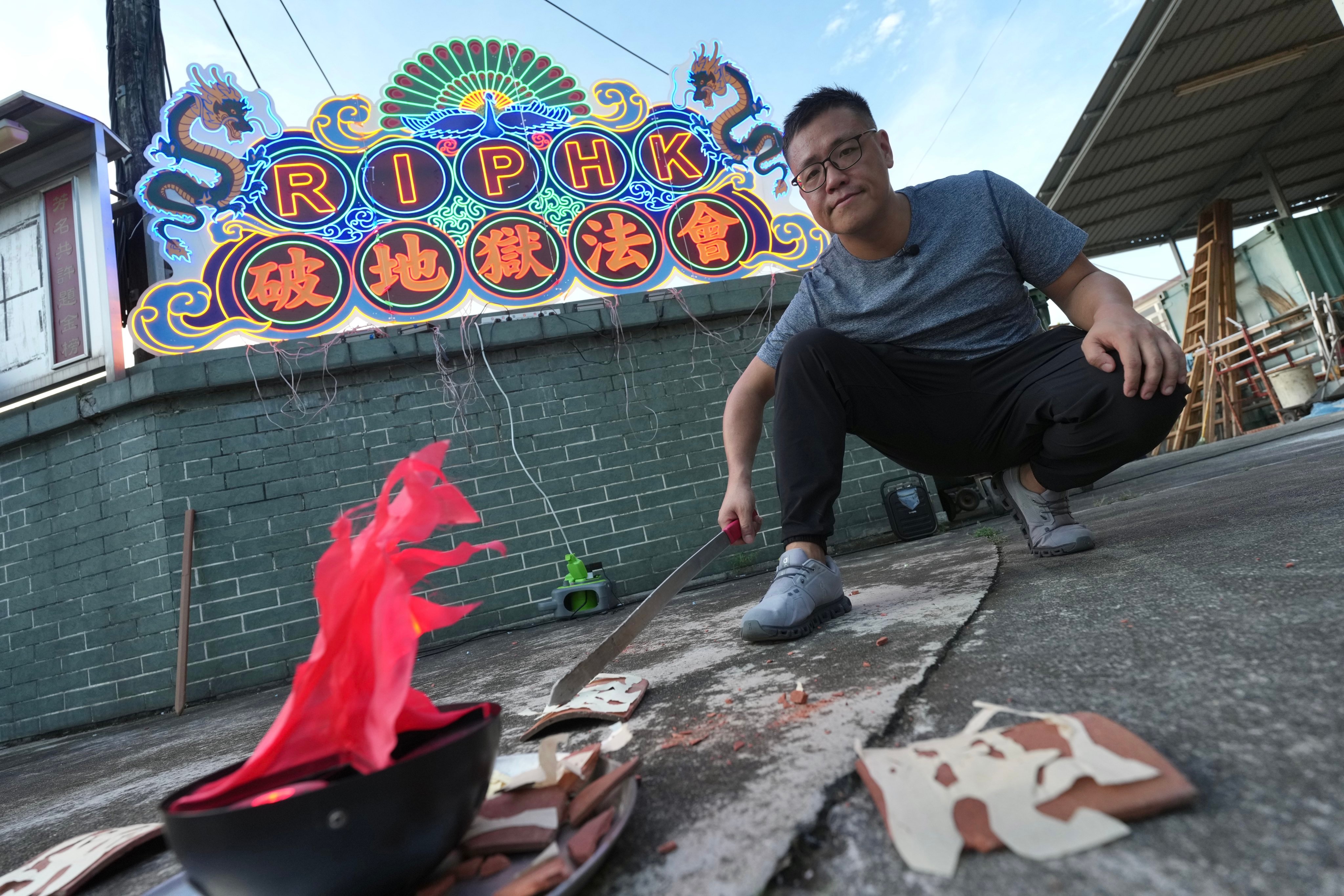 Post reporter Oscar Liu tries the “breaking hell’s gate” ritual at Tin Hau Temple in Yuen Long. Photo: Karma Lo
