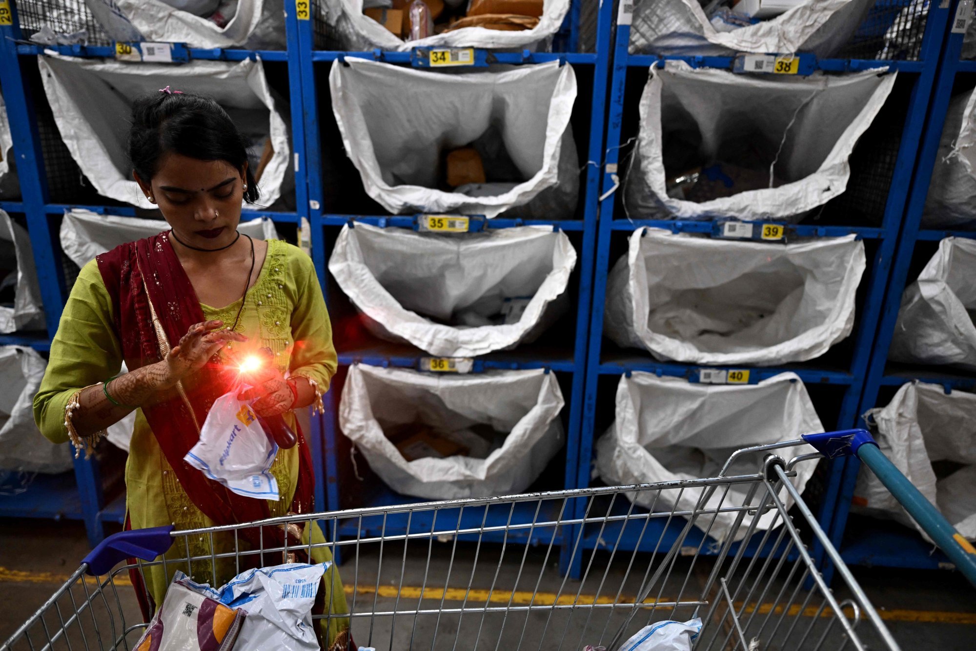 A worker scans packages for dispatch from an e-commerce fulfilment centre in Haryana last month. Photo: AFP