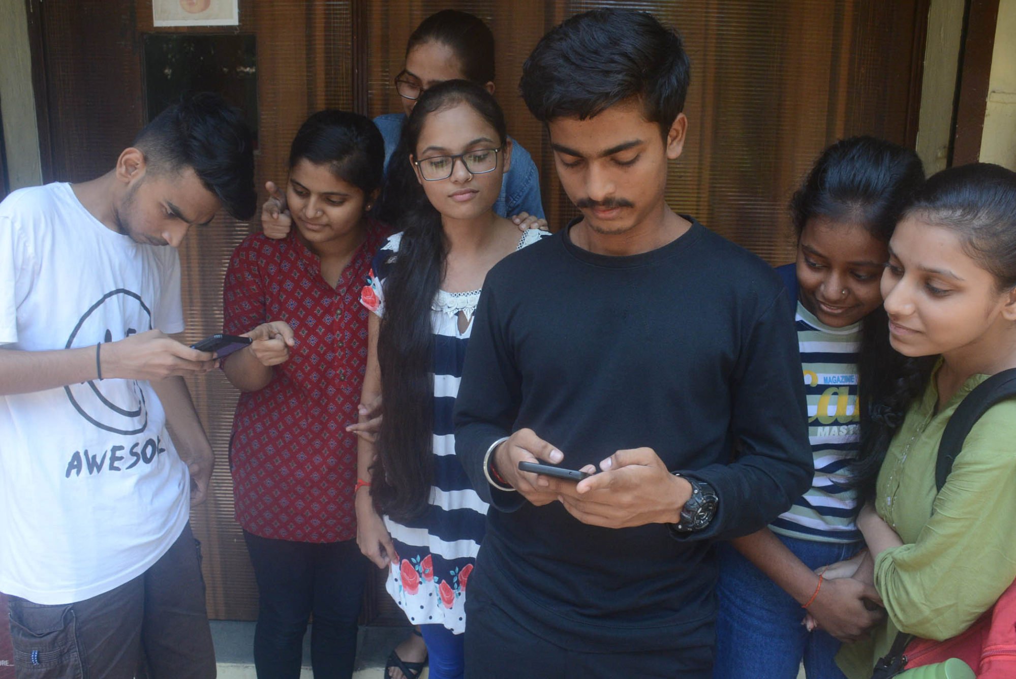 Students check their mobile phones in Thane, a city just outside Mumbai, India. Photo: Hindustan Times/Getty Images