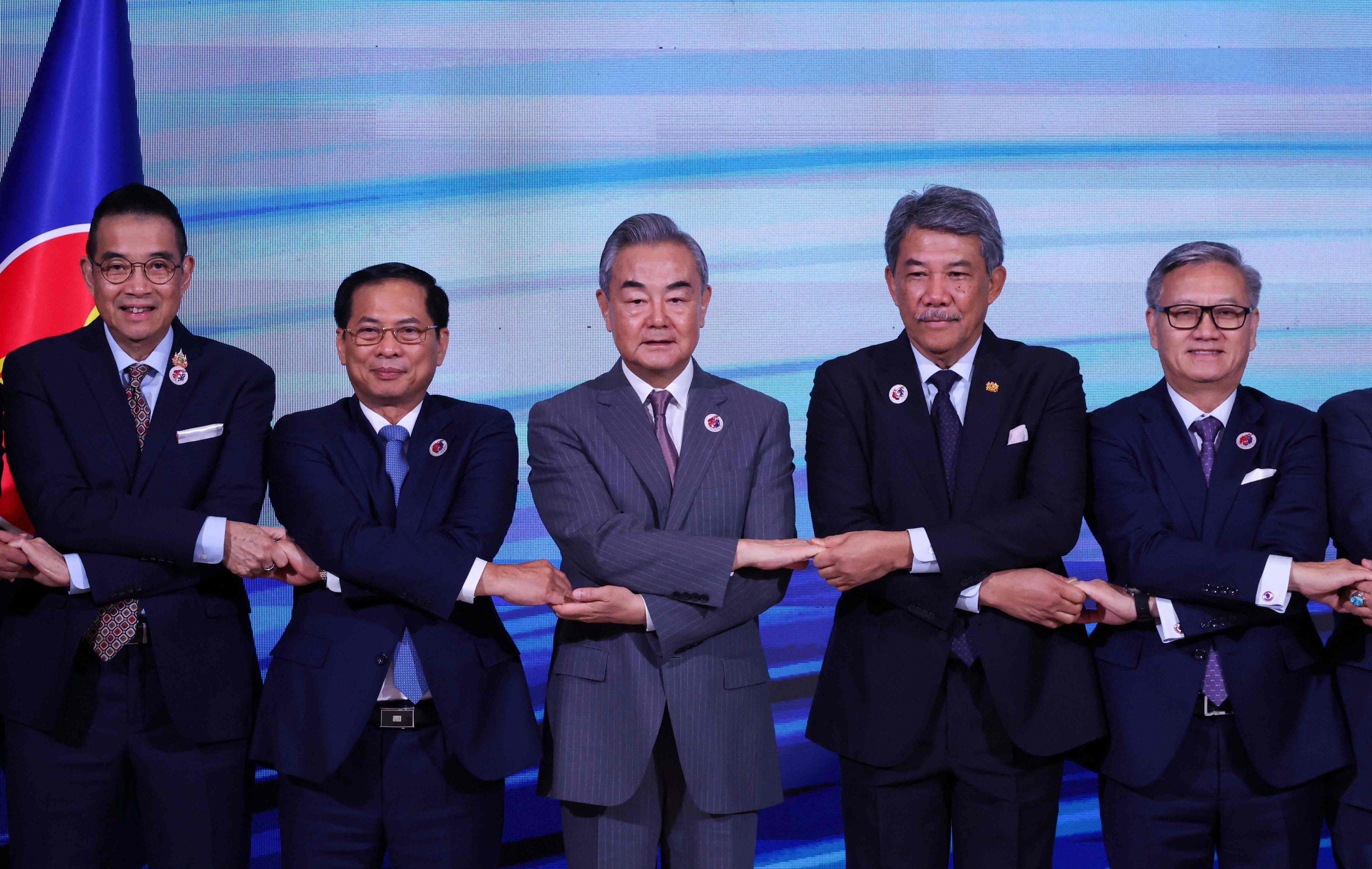 China’s Foreign Minister Wang Yi (centre) joins hands with his Southeast Asian counterparts at an Asean meeting in July. Photo: AFP