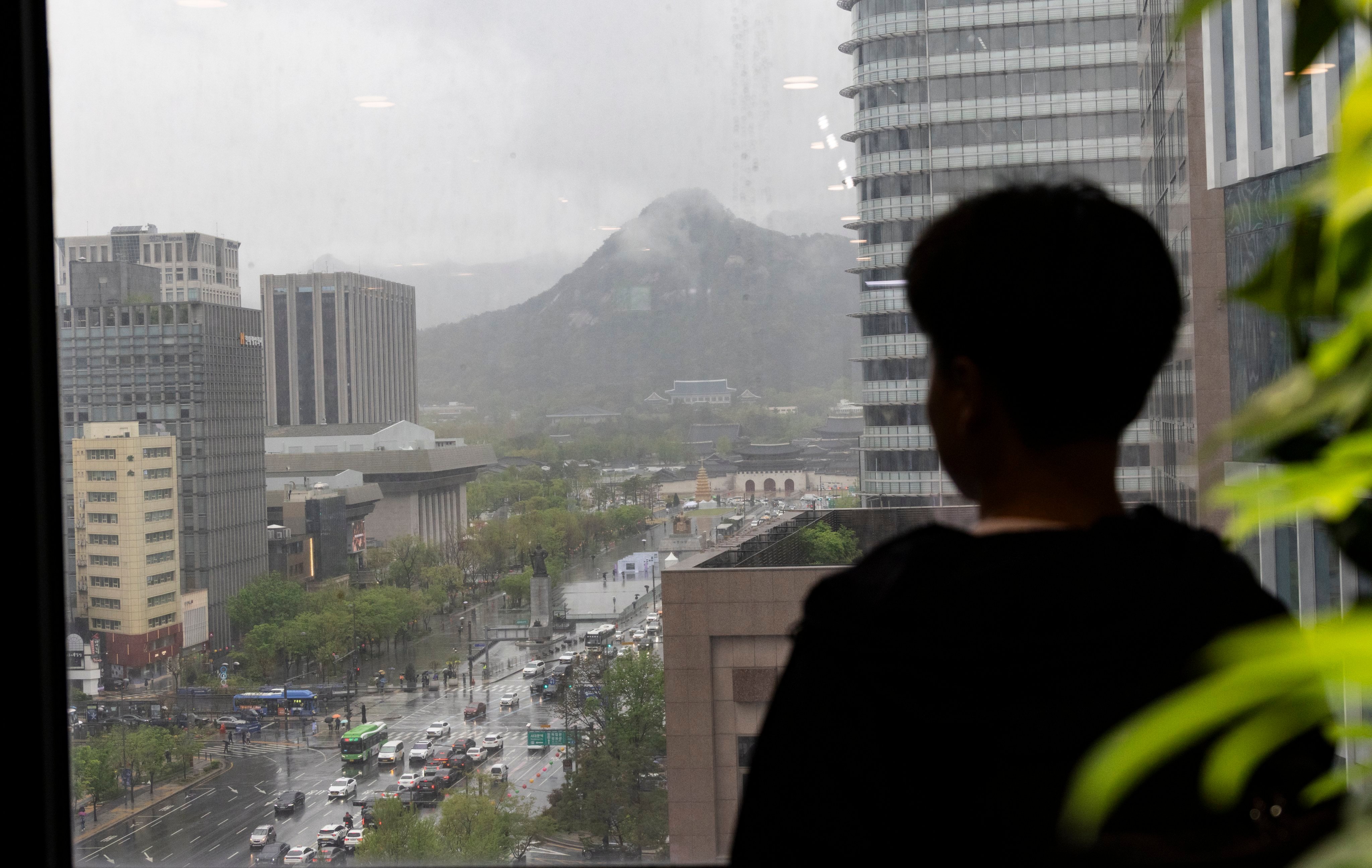A North Korean defector looks from a balcony in Seoul, South Korea. Photo: EPA-EFE