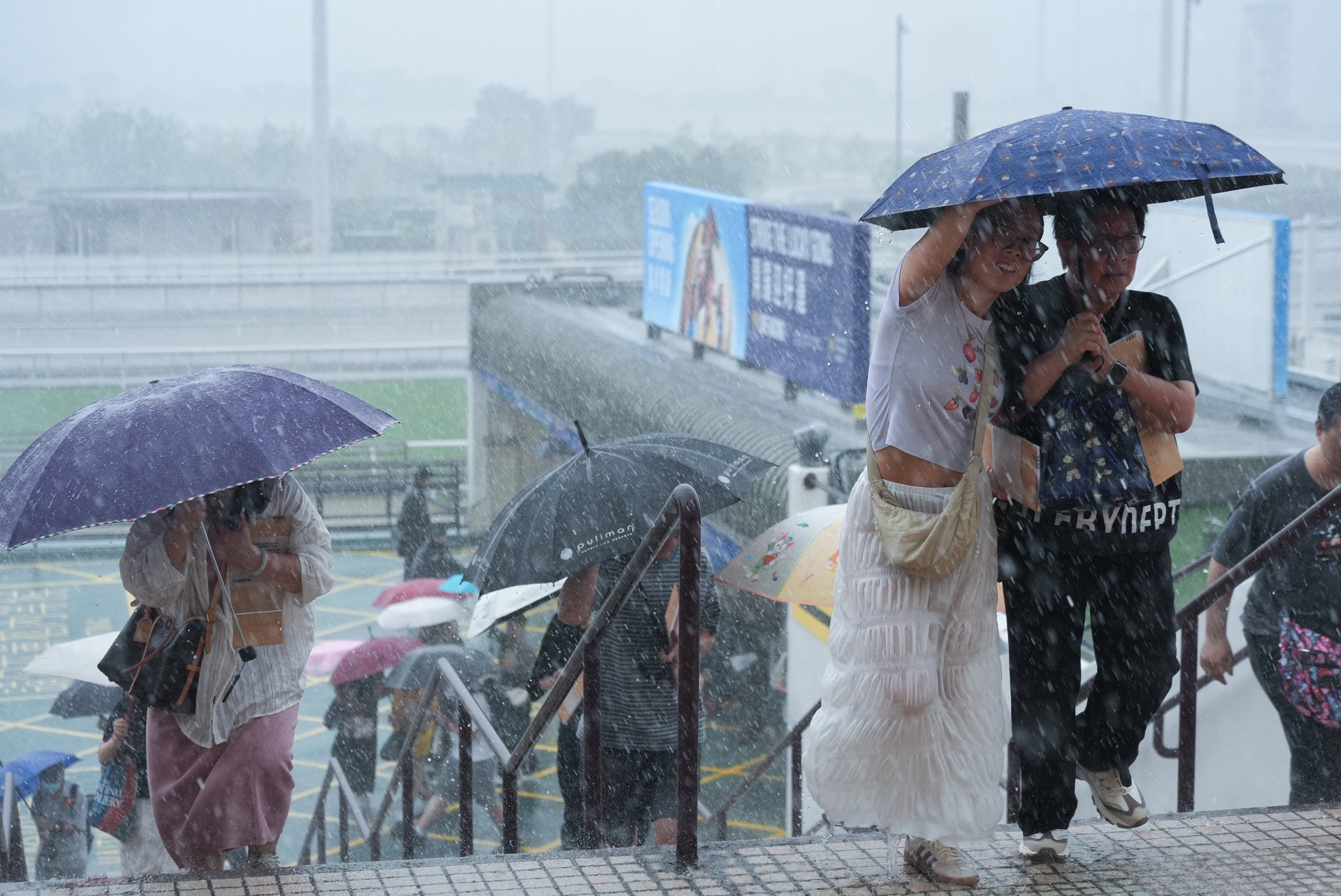 Race fans braved the heavy rain that battered Hong Kong on Sunday for the first meeting of the new season at Sha Tin Racecourse. Photo: Eugene Lee