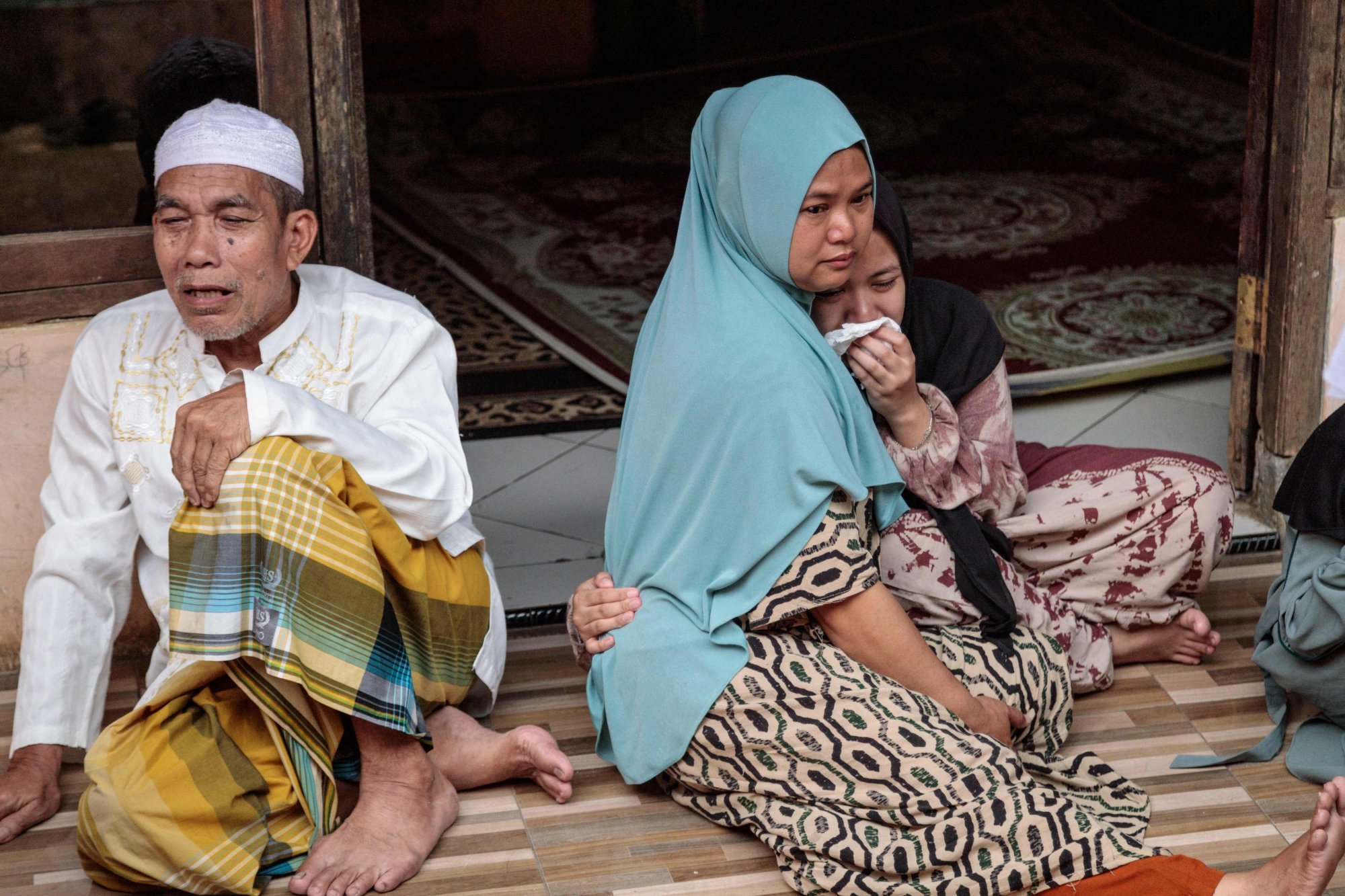Family members of a victim grieve after a community Islamic study hall collapsed in Bogor, West Java, Indonesia on Sunday. Photo: AFP
