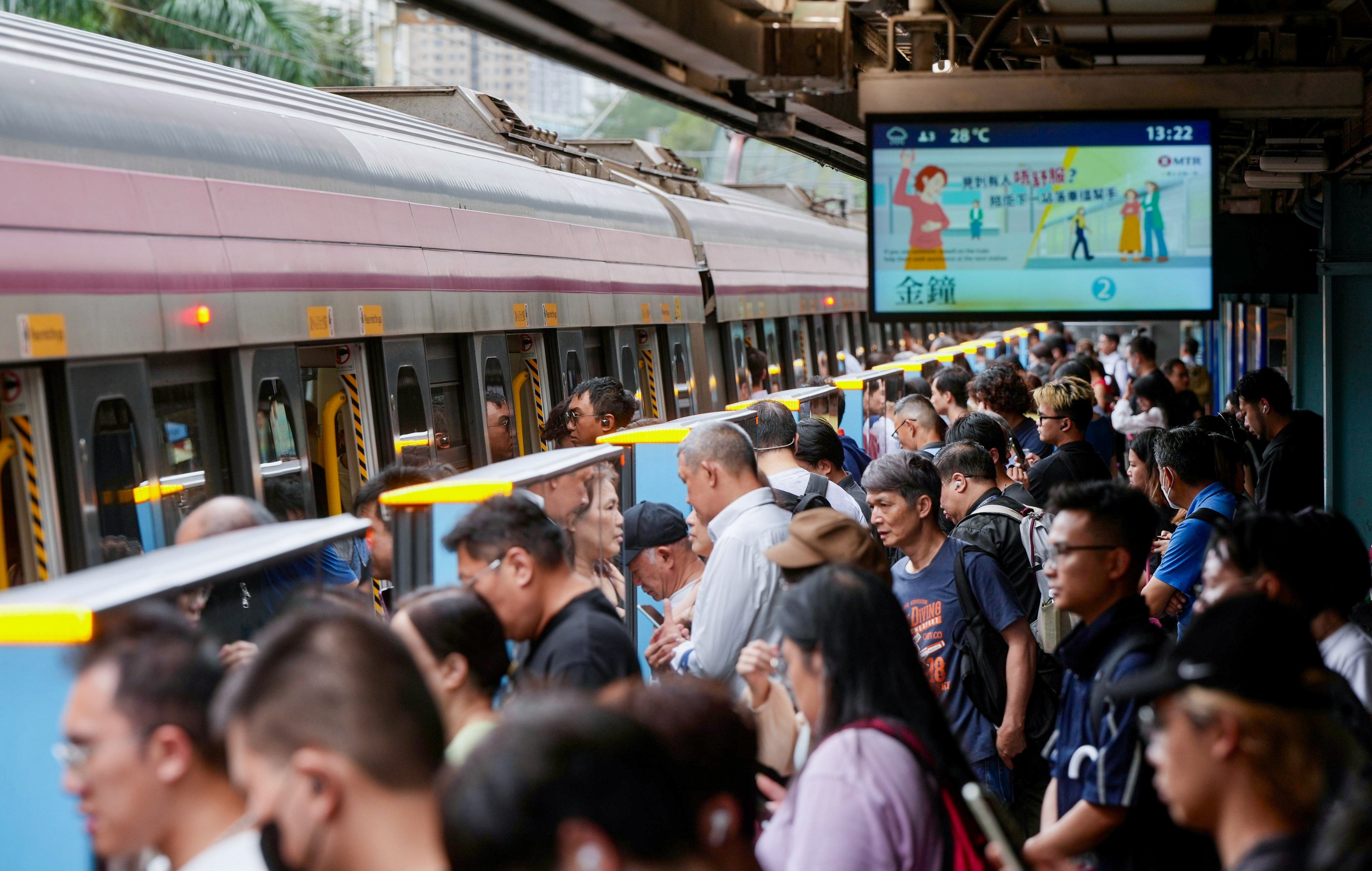 Residents board an MTR train at Tai Wai station after the typhoon signal was lowered. Photo: Sam Tsang