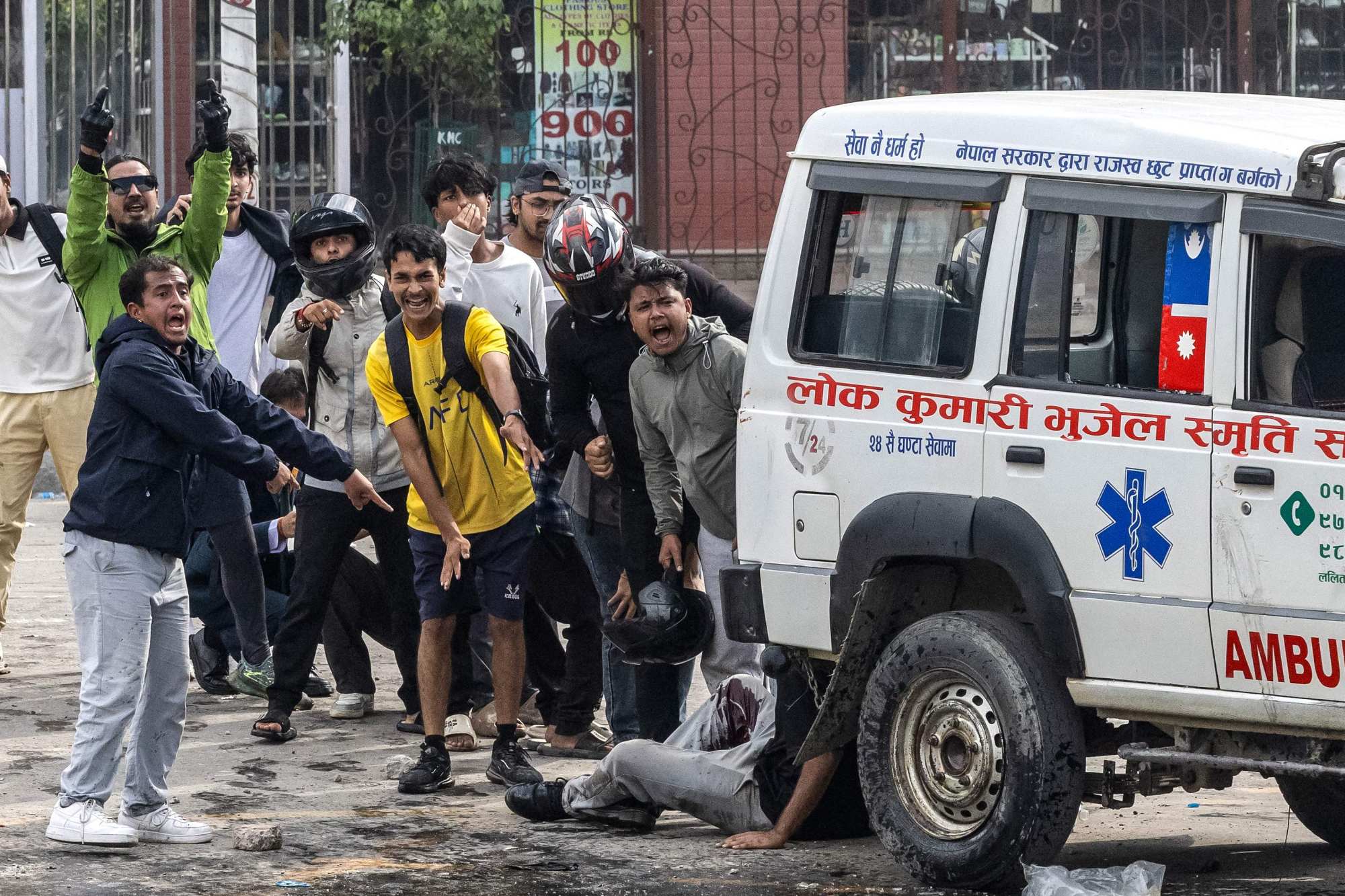 Demonstrators react after a person is injured in a clash with riot police during Monday’s protest. Photo: AFP