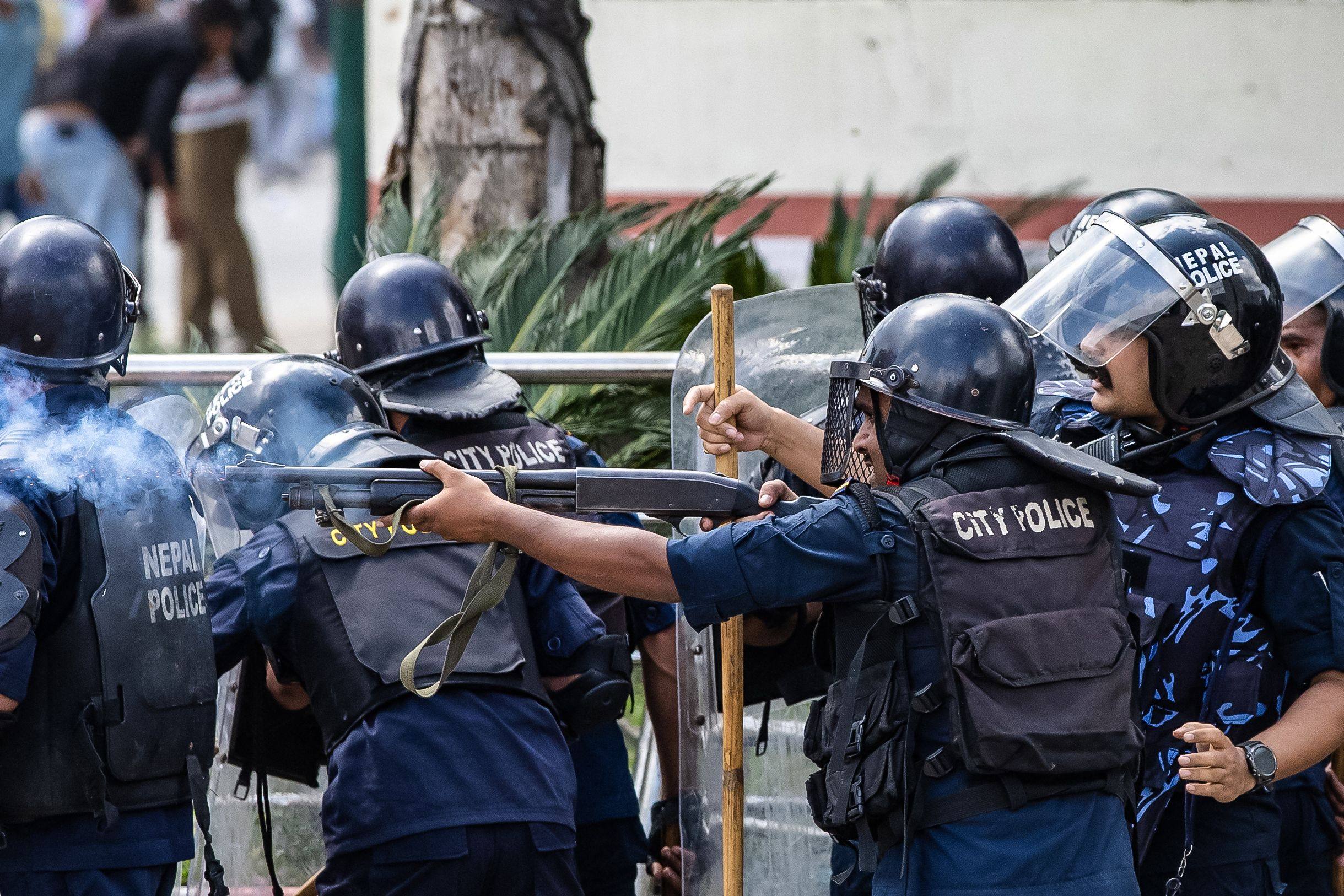 Riot police fire tear gas during a protest outside parliament in Kathmandu, Nepal, on Monday. Photo: AFP