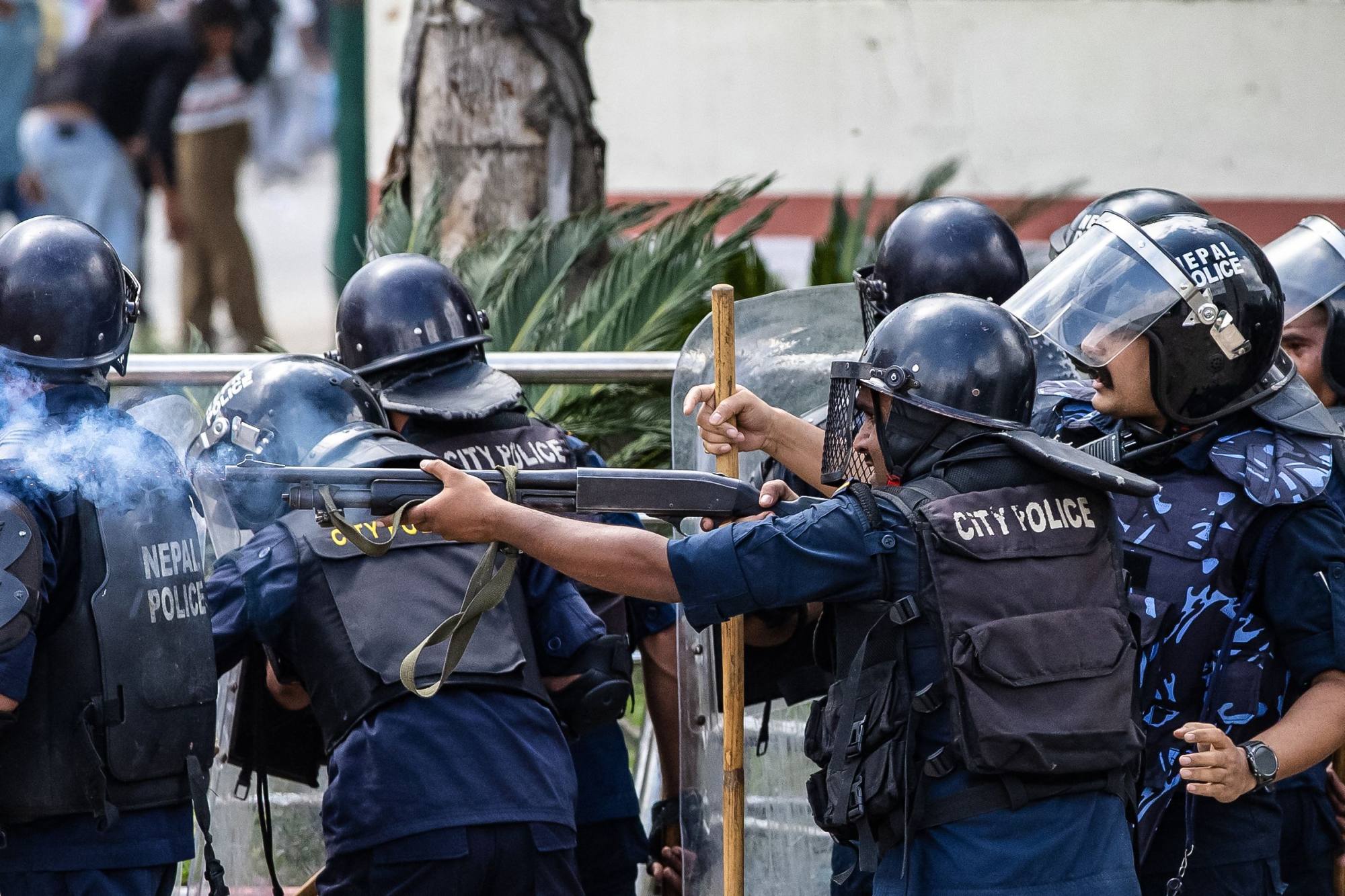 Riot police fire tear gas during a protest outside parliament in Kathmandu on Monday. Photo: AFP