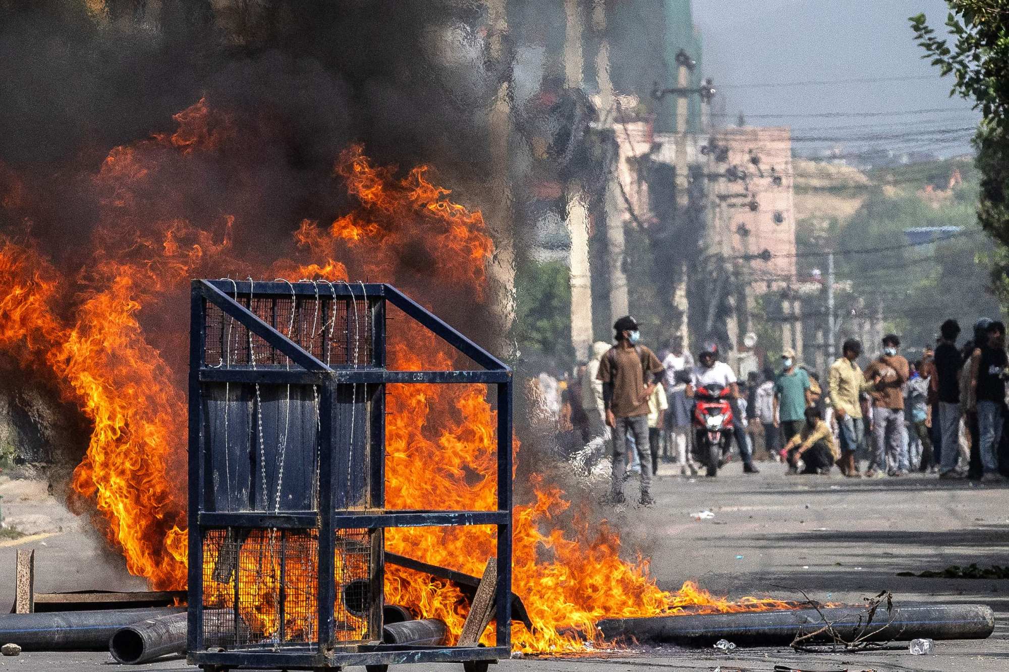 A police barricade is seen after being set alight during Monday’s protest in Kathmandu. Photo: AFP