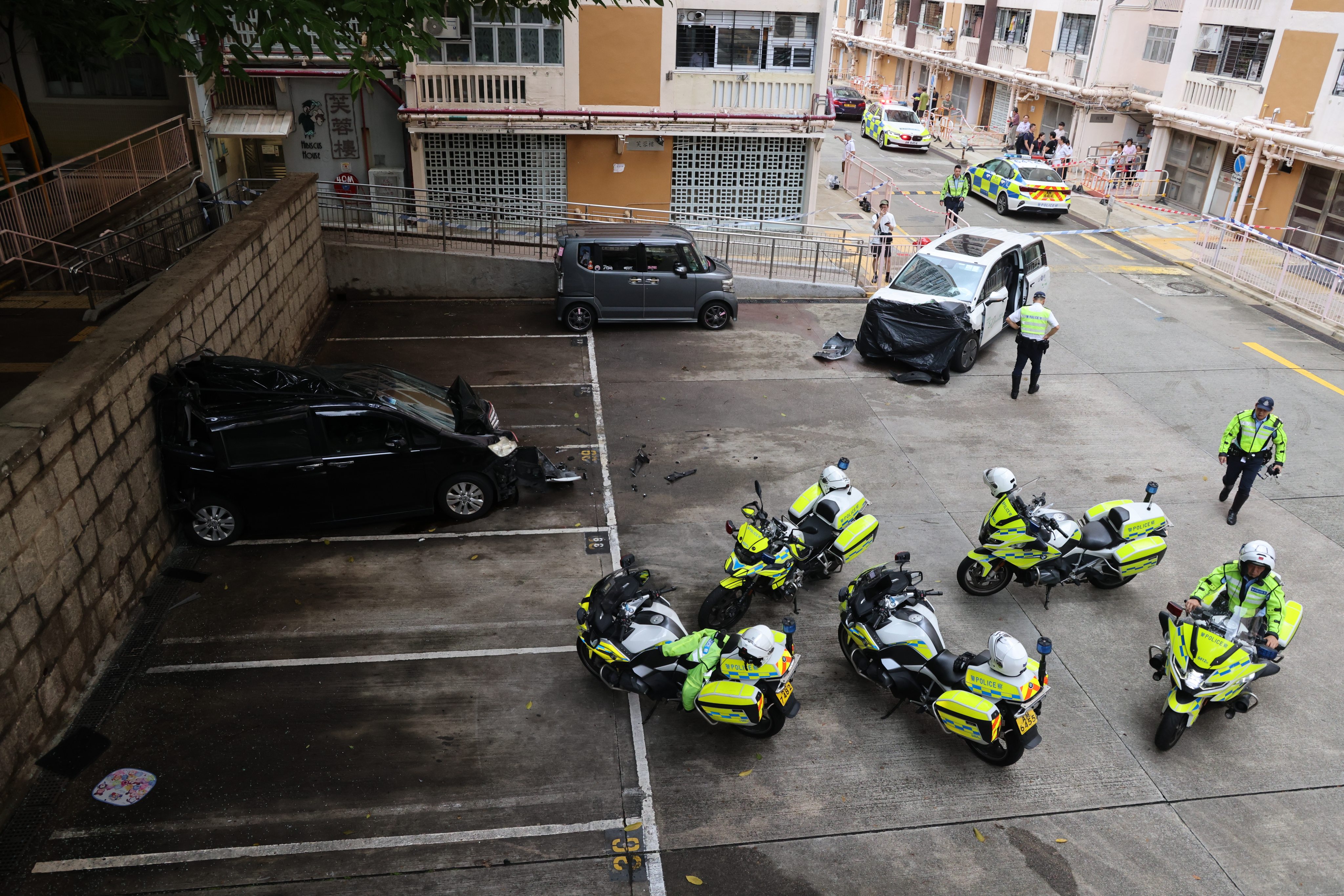 A woman has died after being hit by a CLP Power vehicle, right, which subsequently collided with another car, left, outside of the Ma Tau Wai Estate in To Kwa Wan. Photo: Jelly Tse