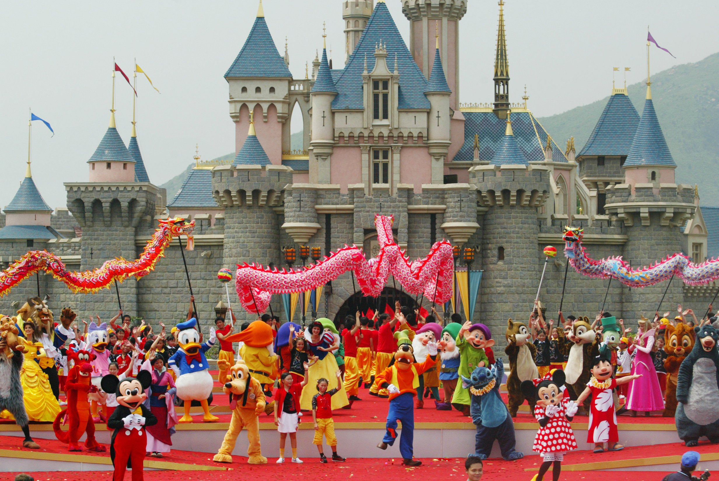 Mickey and Minnie Mouse perform on stage with other characters in front of the castle of Sleeping Beauty at the official opening of Hong Kong Disneyland on September 12, 2005. Photo: SCMP Archives
