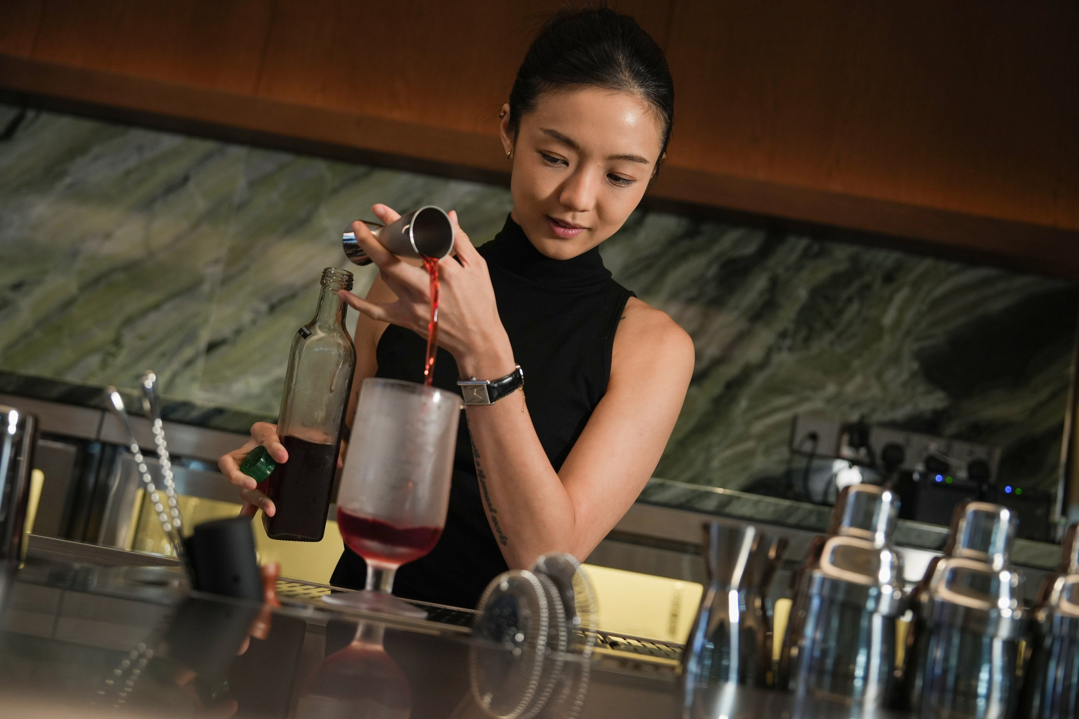 Award-winning bartender Shelley Tai pours a drink at her new bar, Mius, on Gough Street in Central, Hong Kong. Photo: Sun Yeung