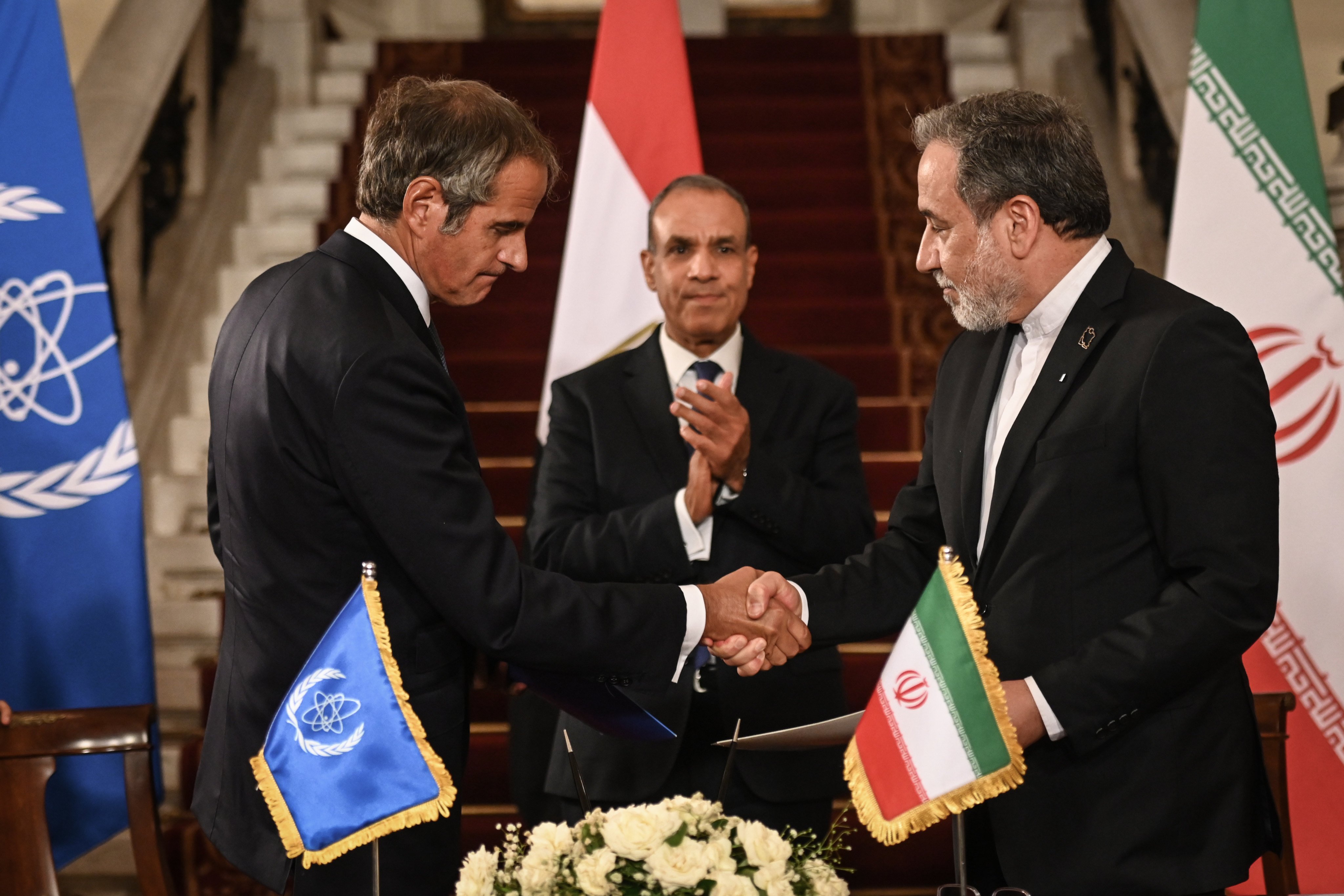 IAEA chief Rafael Grossi (left) and Iranian Foreign Minister Abbas Araghchi shake hands after signing an agreement in presence of Egyptian Foreign Minister Badr Abdelatty (centre) at Tahrir Palace in Cairo on Tuesday. Photo: dpa