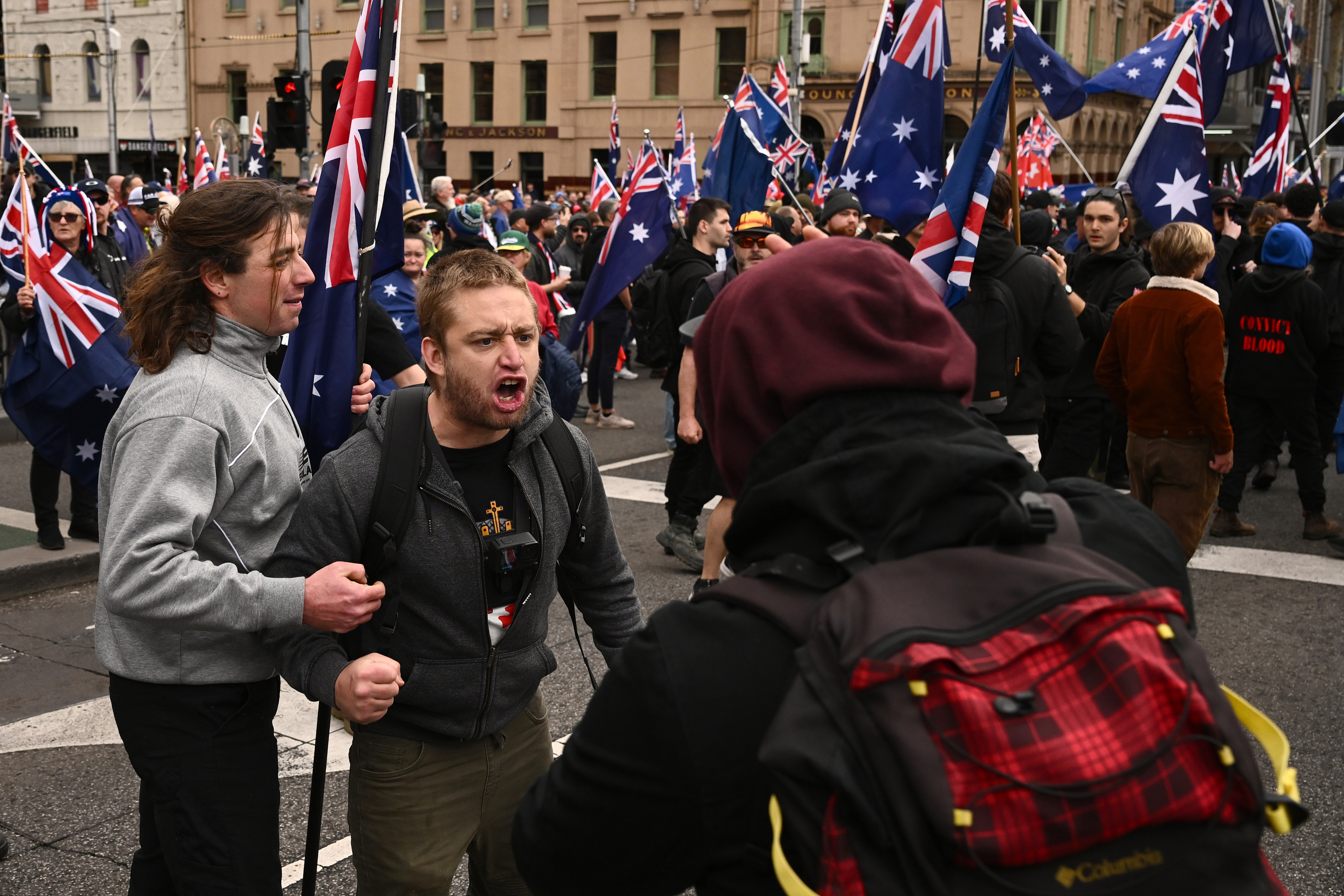 A scuffle breaks out as protesters gather outside Flinders Street Station in Melbourne, Victoria, during the “March for Australia” anti-immigration rally. Photo: AAP/DPA