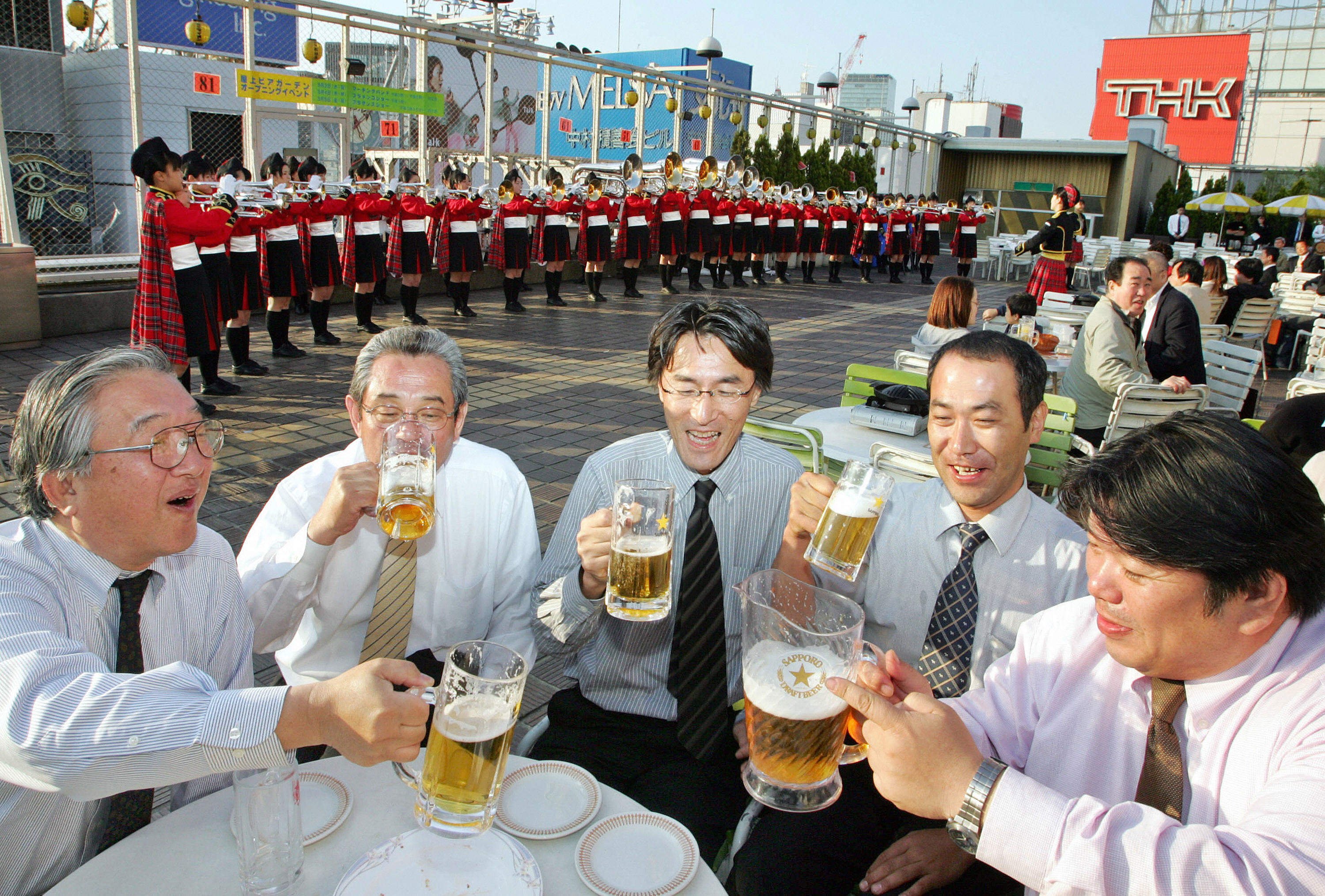 Japanese businessmen enjoy drinking beer at a beer garden on the rooftop of a Tokyo’s department store. Photo: AFP