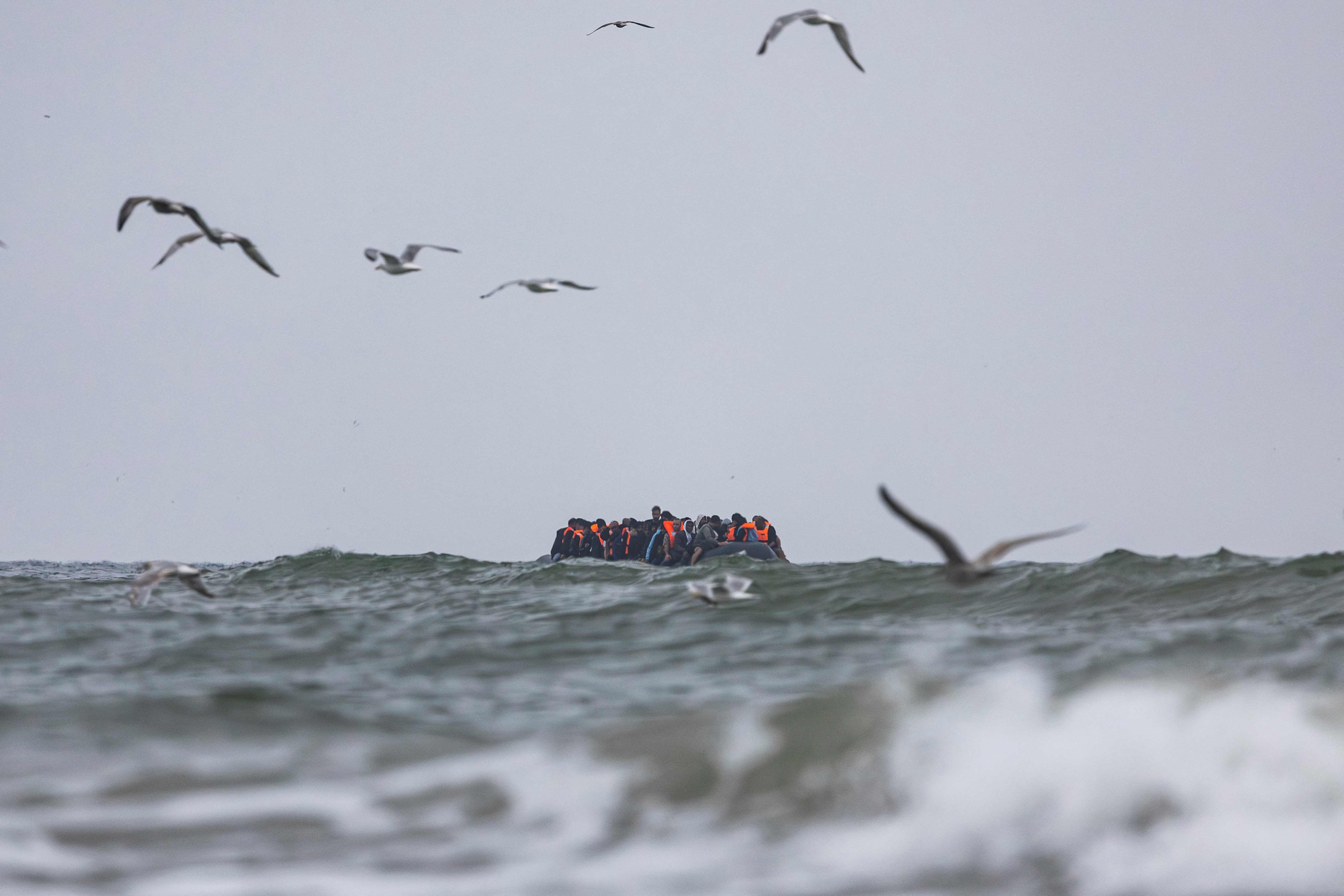 Migrants onboard a smuggler’s boat attempt to cross the English Channel off the beach of Hardelot in Neufchatel-Hardelot, northern France. Photo: AFP