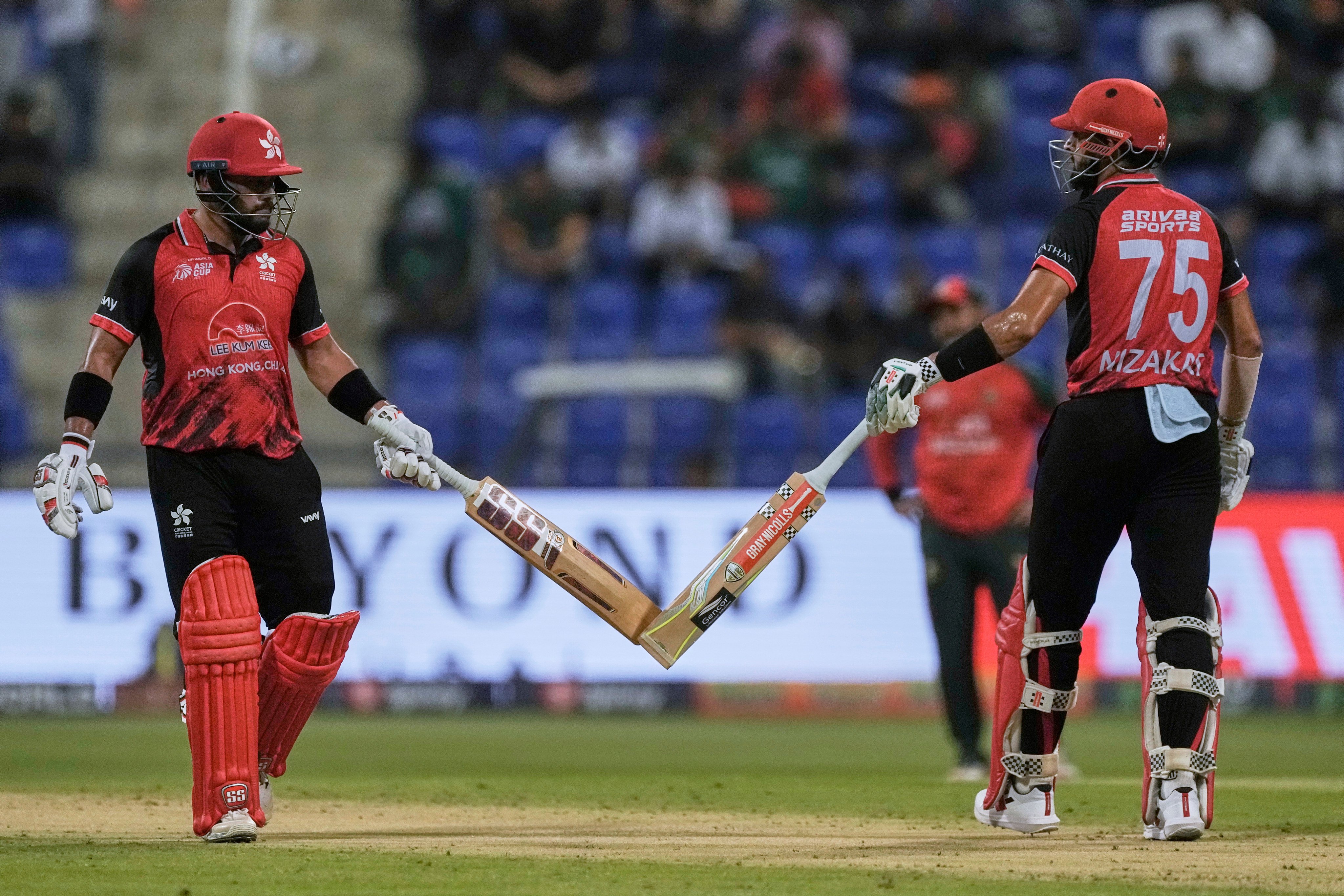 Hong Kong batsmen Nizakat Khan (right) and Zeeshan Ali put  on a third-wicket stand of 41 against Bangladesh at Zayed Cricket Stadium in Abu Dhabi on Thursday. Photo: AP
