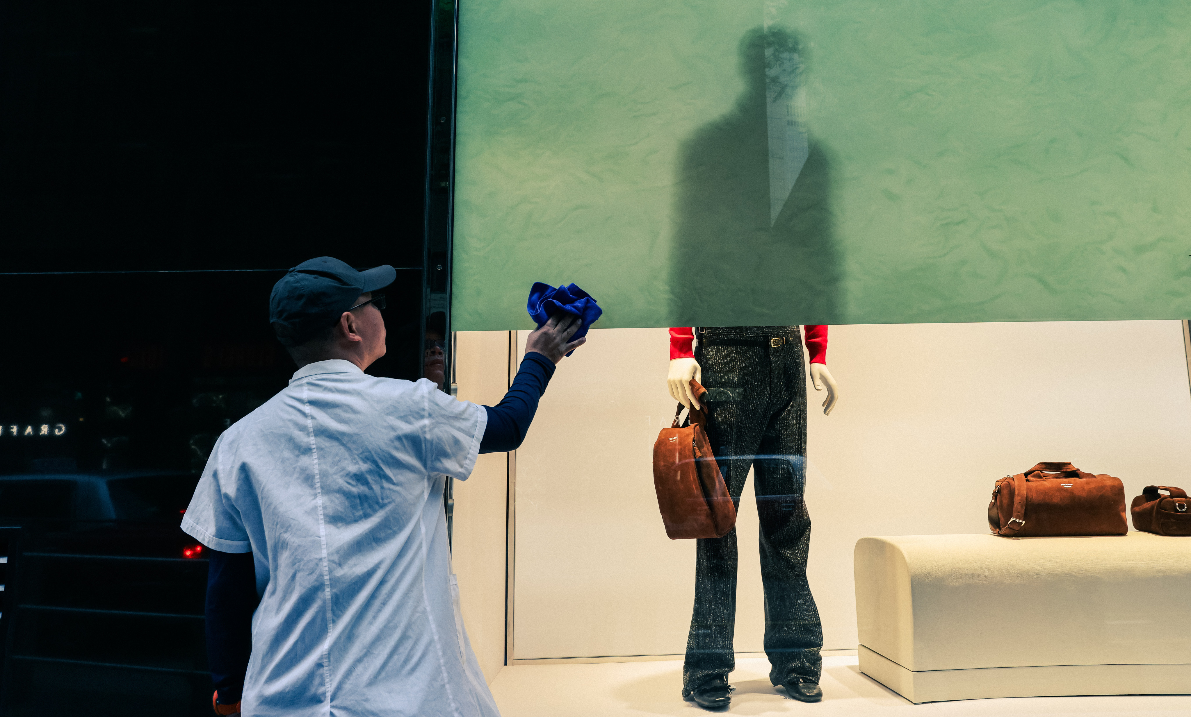 A worker cleans a window display in Central. Photo: Nora Tam