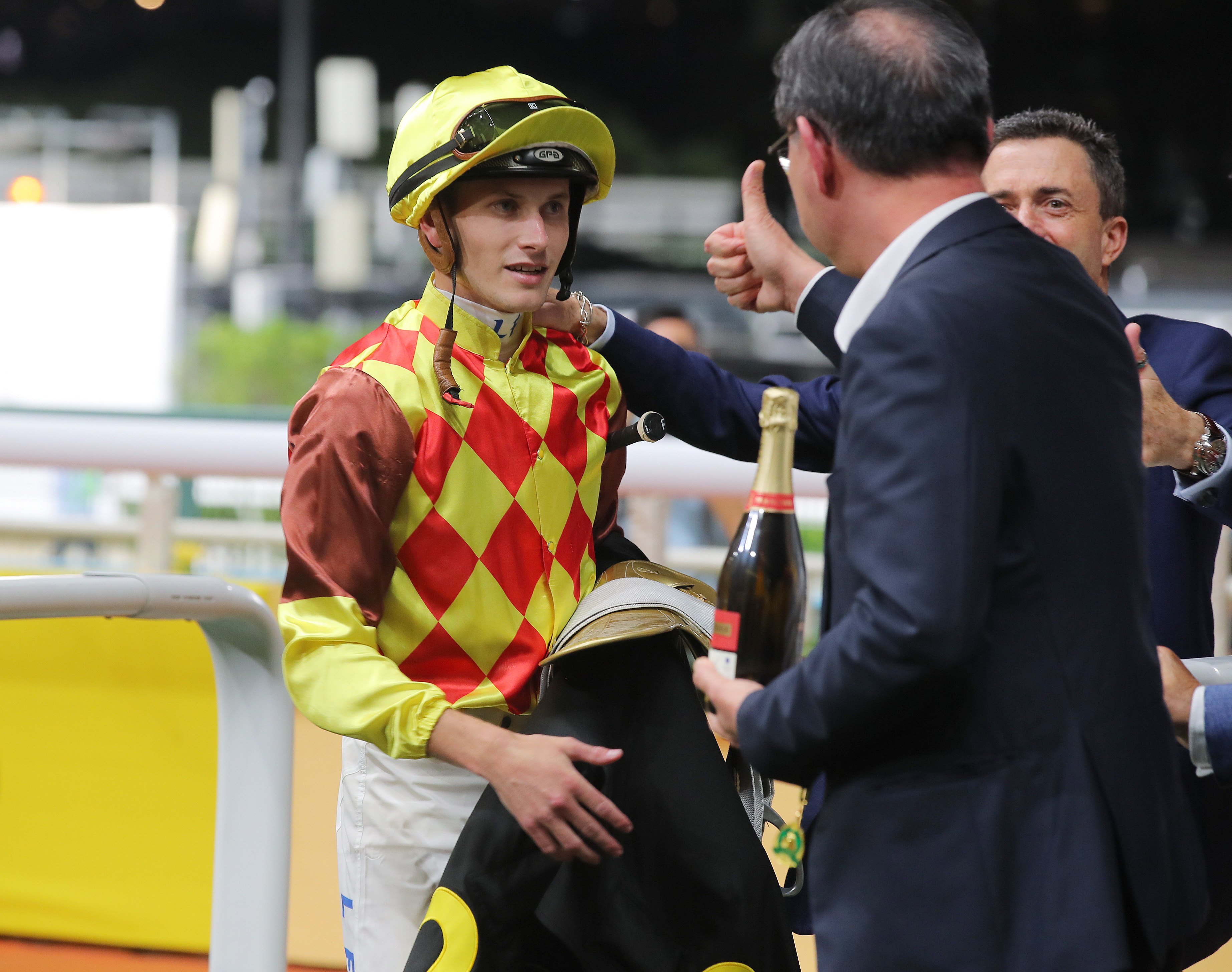 Jockey Luke Ferraris earns the approval of connections after saluting aboard Harmony Fire on Wednesday night. Photo: Kenneth Chan