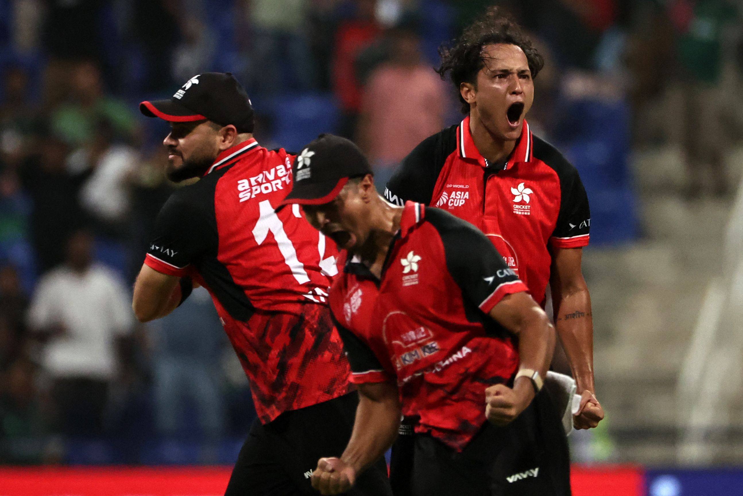 Yasim Murtaza (left) joins the celebrations following a Hong Kong wicket against Bangladesh. Photo: AFP