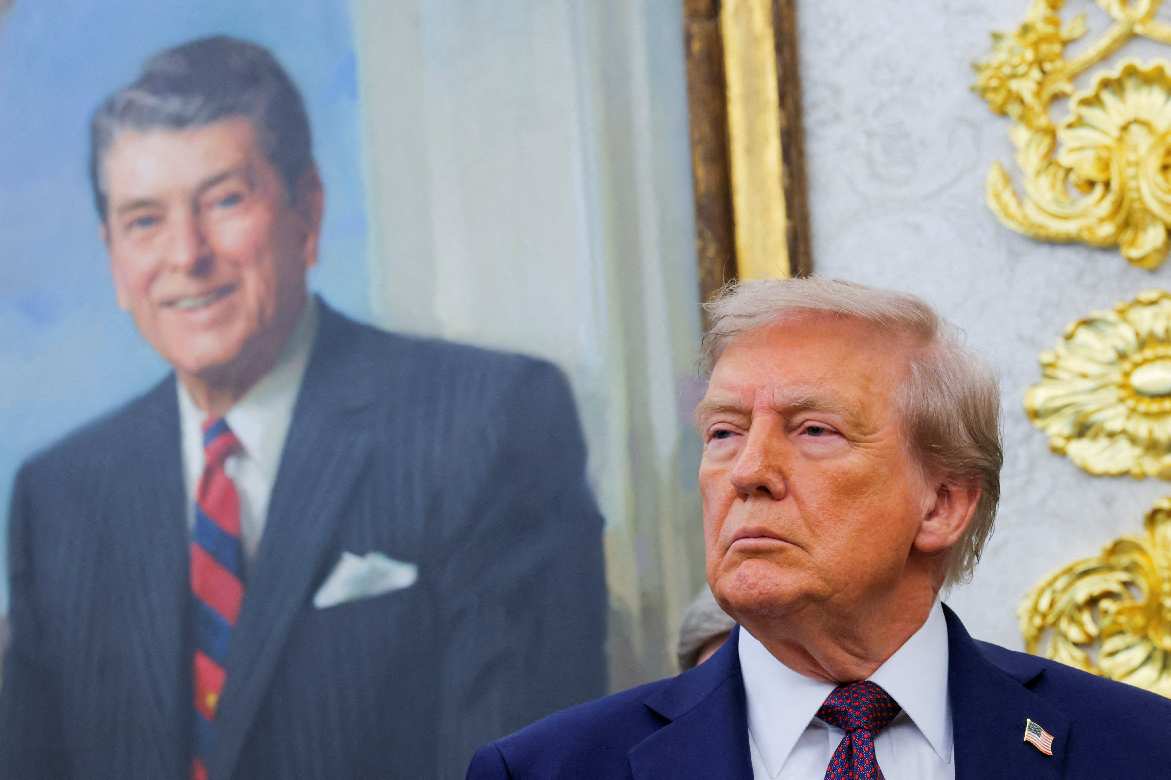 US President Donald Trump stands near a portrait of Ronald Reagan, at the White House in Washington, on September 2. Photo: Reuters