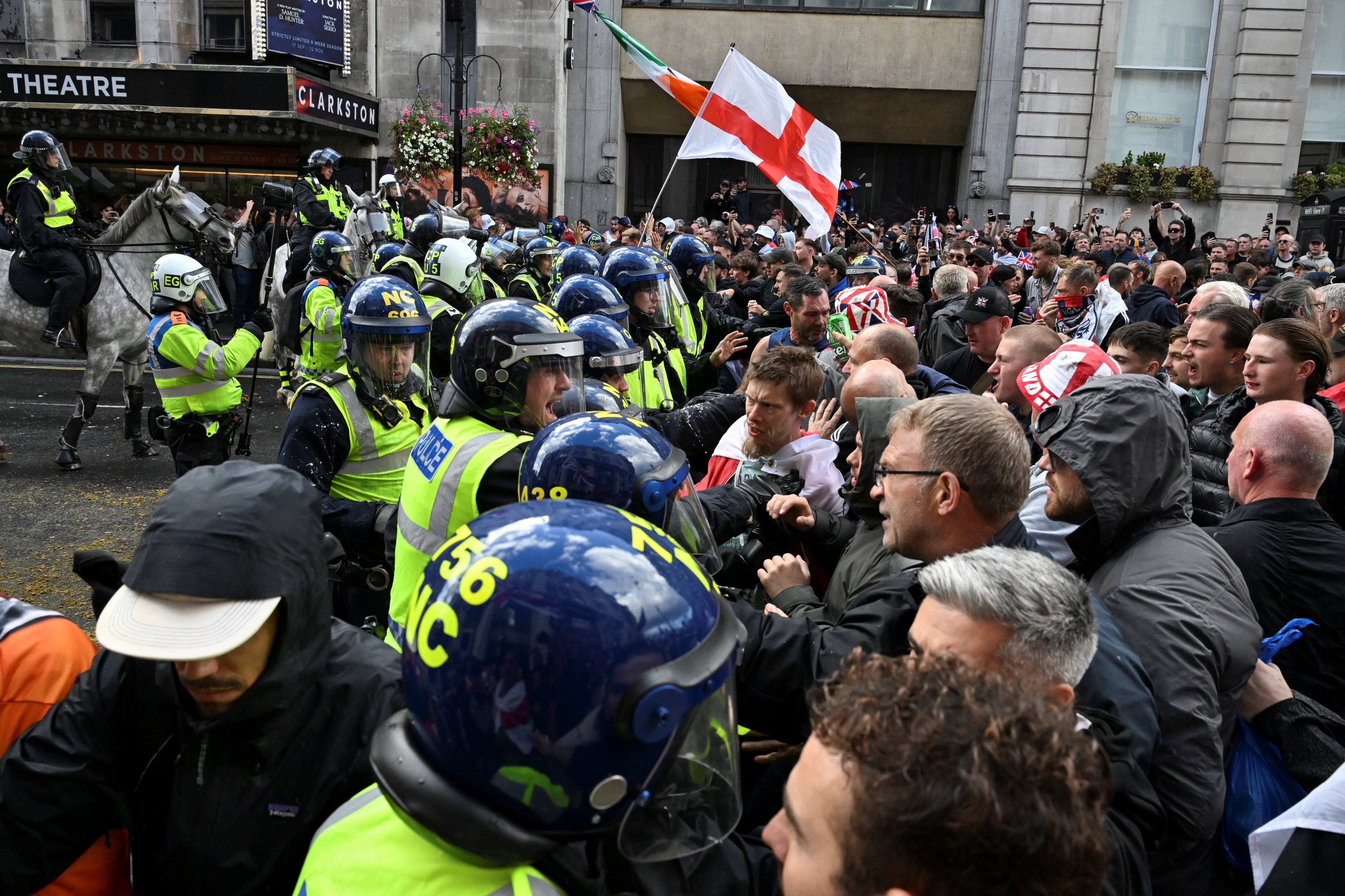 Police officers clash with supporters of British anti-immigration activist Tommy Robinson, during a demonstration in London on Saturday. Photo: Reuters
