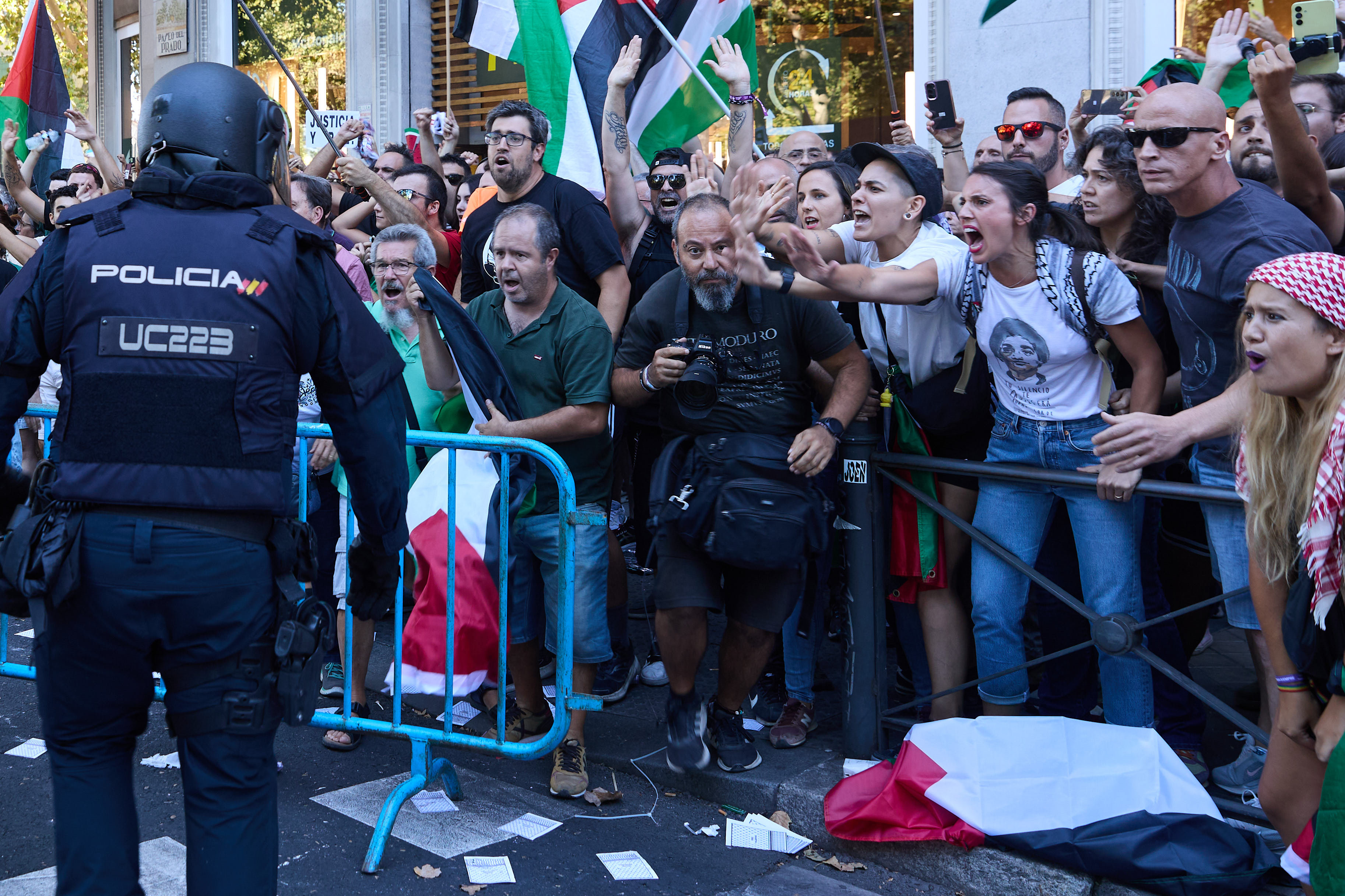 Protesters clash with police as they block the road to disrupt the 21st stage of the Spanish cycling race La Vuelta from Alalpardo to Madrid on Sunday. Photo: Europa Press / dpa