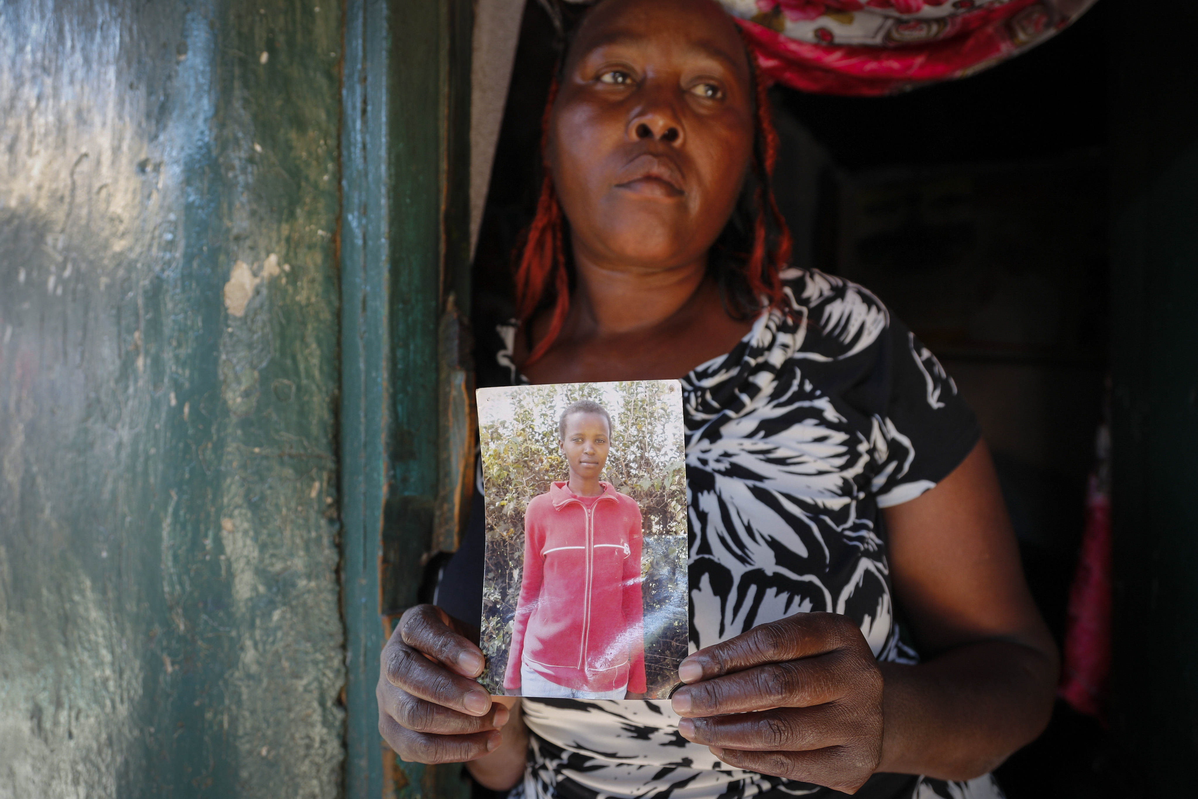 Rose Wanyua Wanjiku, elder sister to Agnes Wanjiru, holds a photograph of her in 2021. Photo: AP